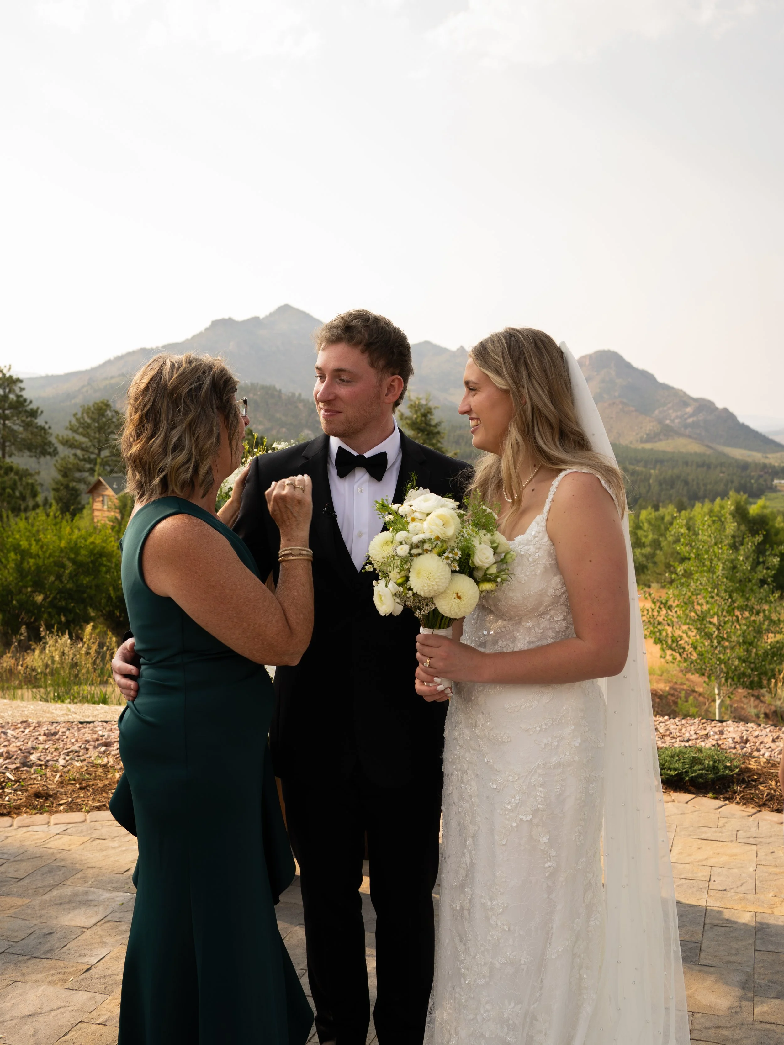 A meaningful interaction in Woodland Park, Colorado, capturing connection between the couple and loved ones.