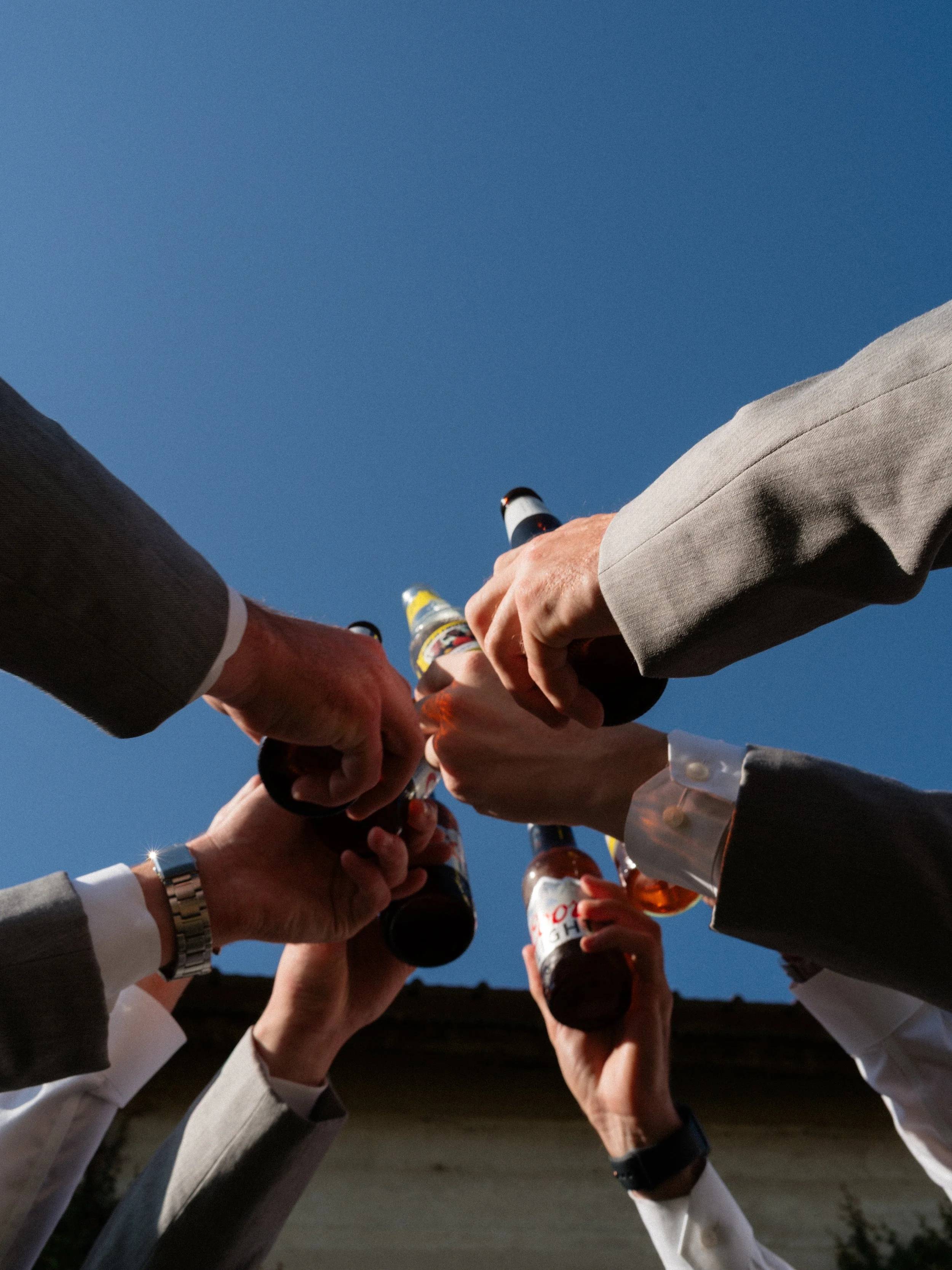 A celebratory champagne toast captured from below in Montgomery, Texas, highlighting energy, friendship, and the joy of the wedding day.