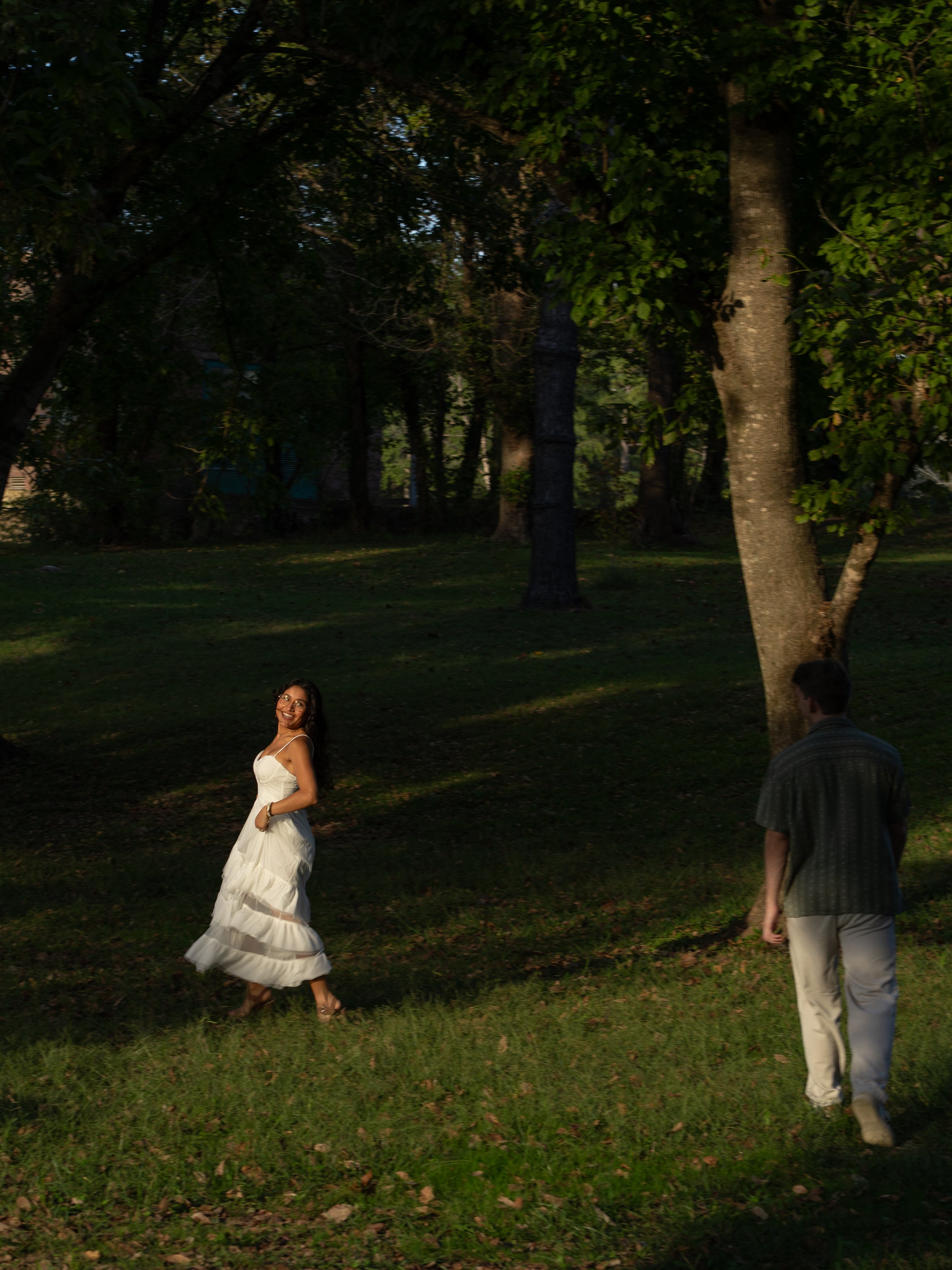 A cinematic, wide engagement scene in Mammoth Springs, AR, capturing the couple within soft light and expansive nature.