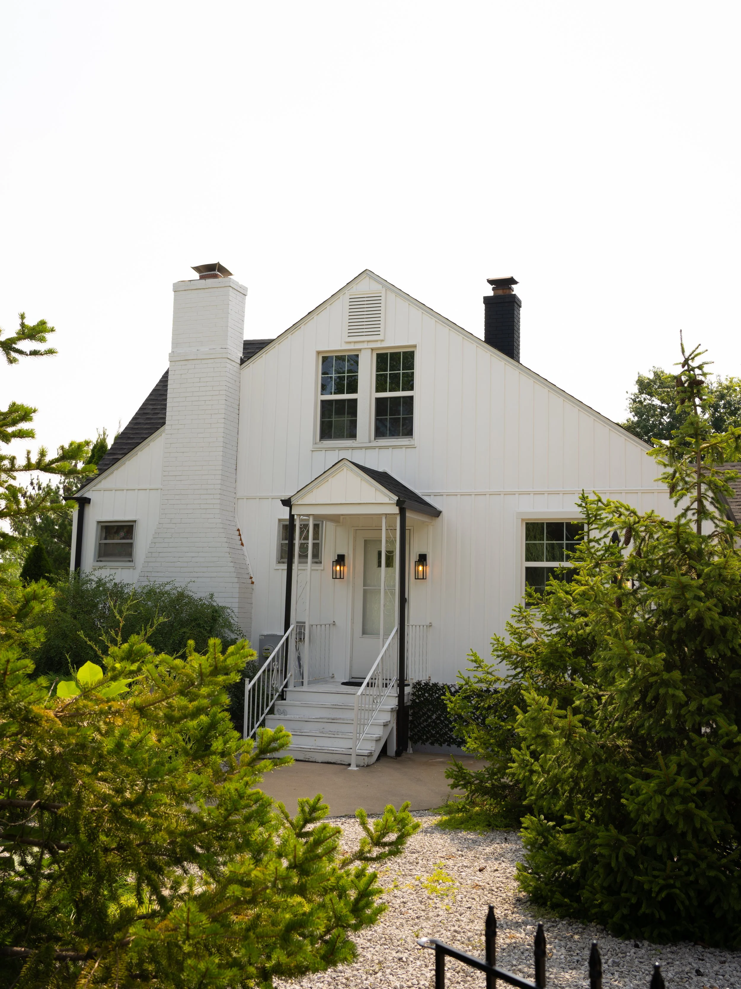 A charming venue exterior in O’Fallon, MO, framed by greenery and soft natural light.