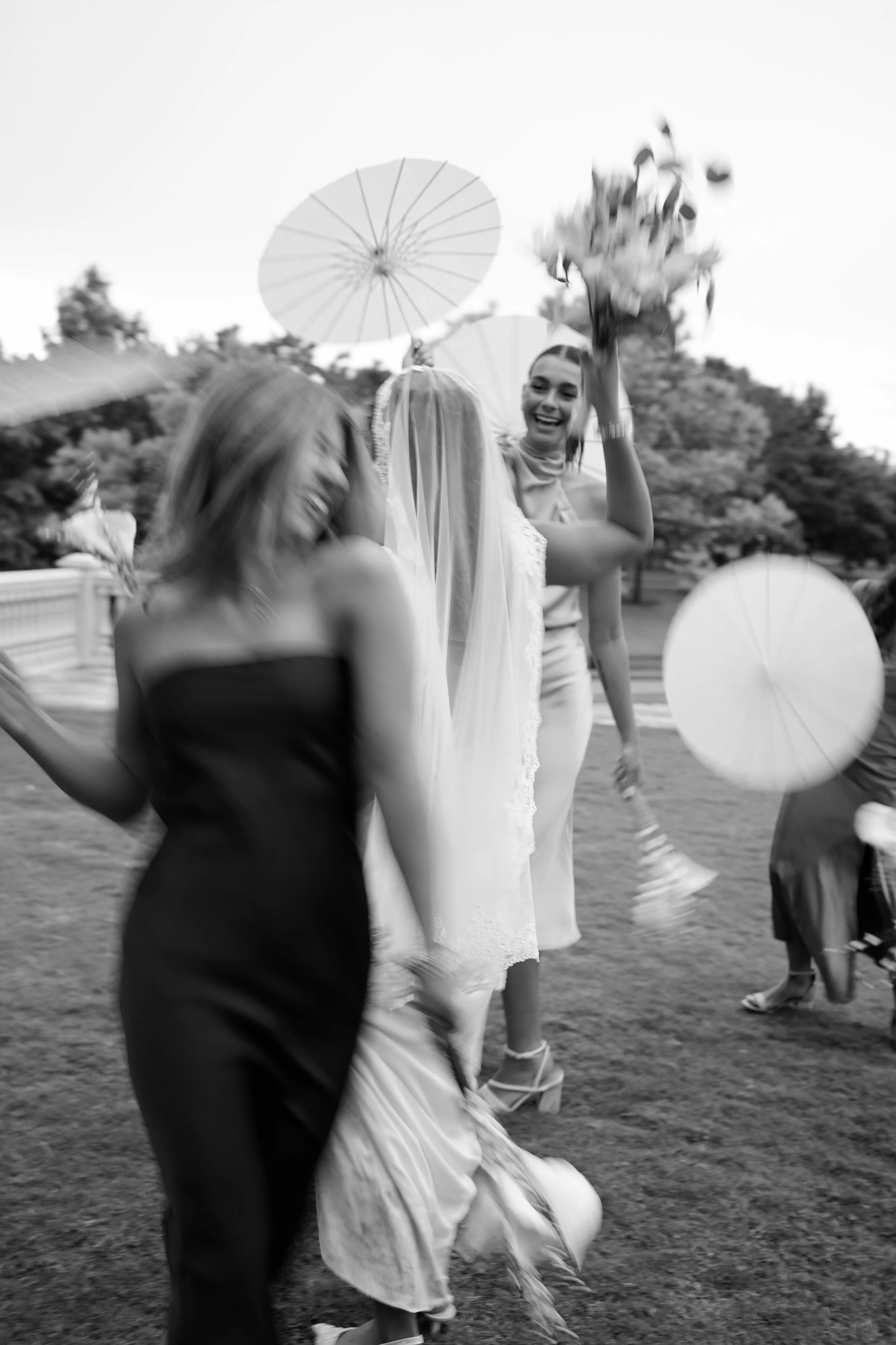 A joyful black-and-white moment in Richmond, Texas, capturing playful energy and movement from the bridal party.