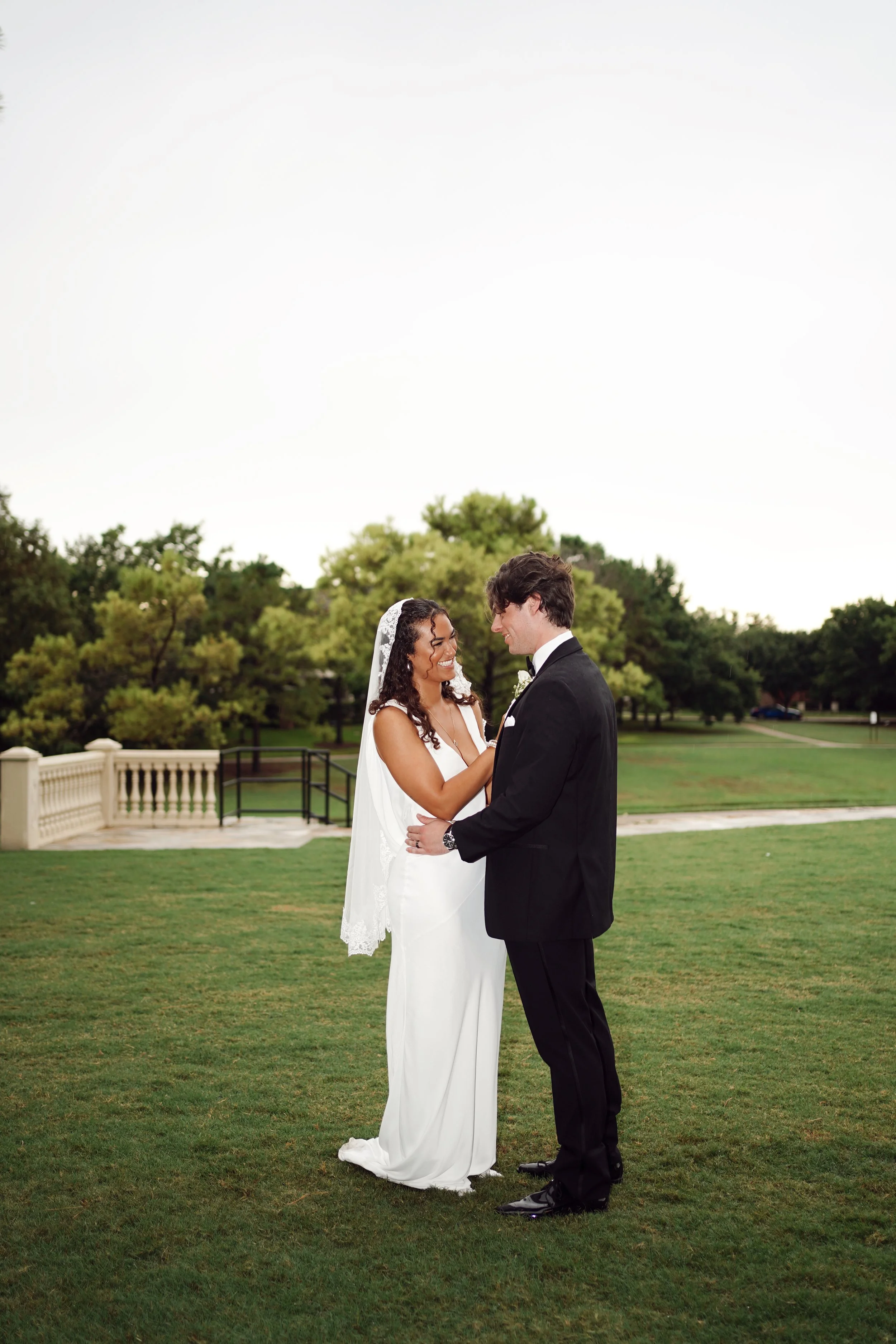 A timeless couple’s portrait in Richmond, Texas, set against an open landscape with soft natural light.