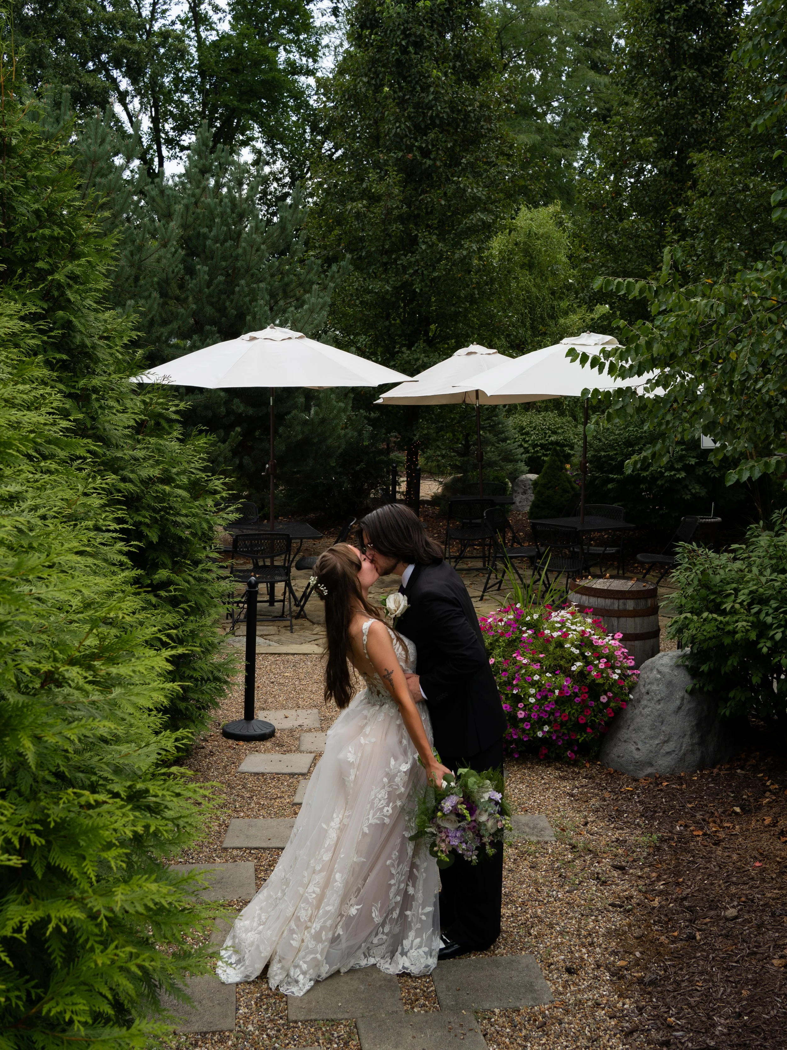 A romantic garden portrait in O’Fallon, Missouri, capturing intimacy surrounded by lush greenery.