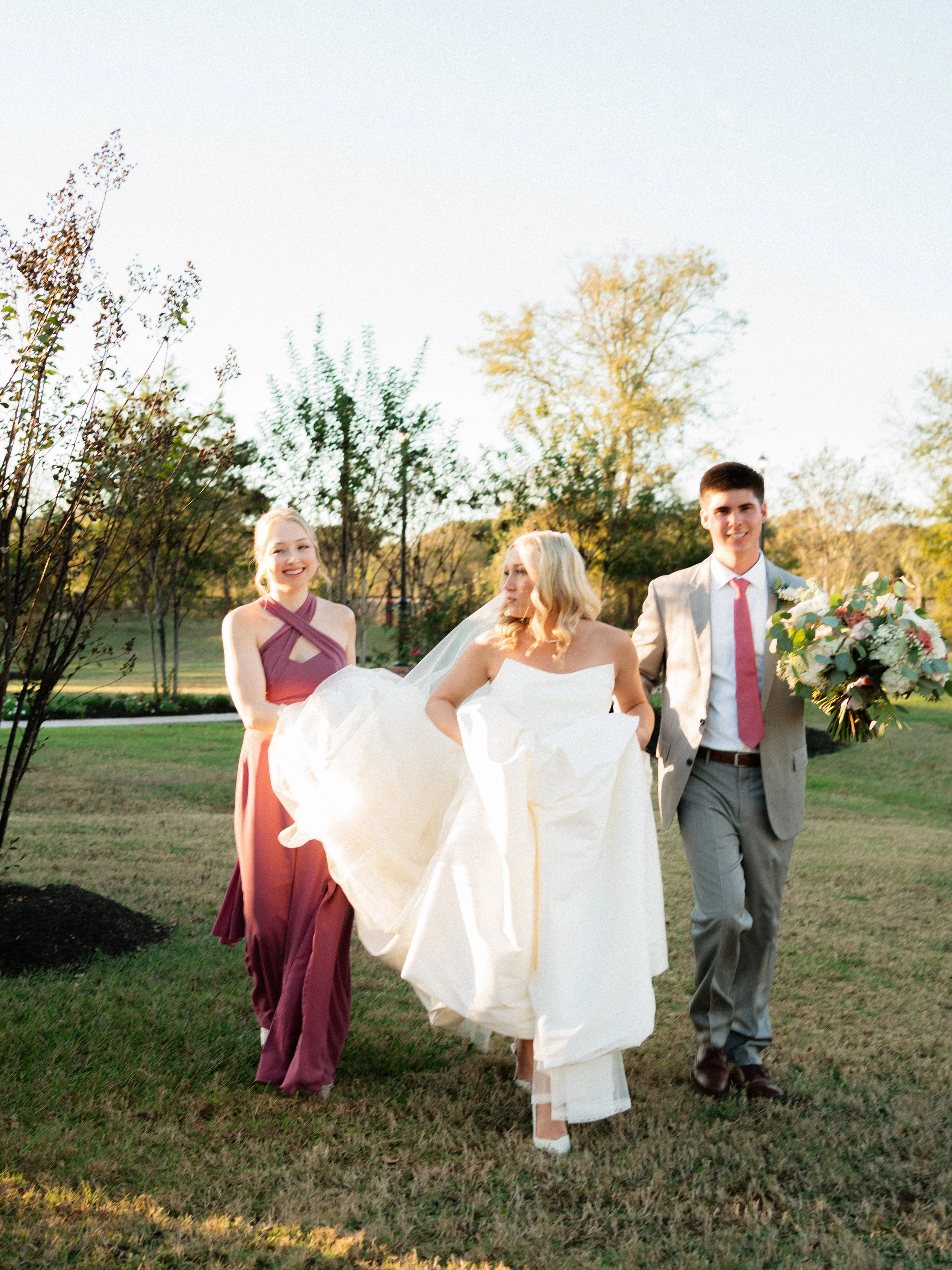 The bride and bridal party walk together in Montgomery, TX, capturing natural movement and joyful celebration.