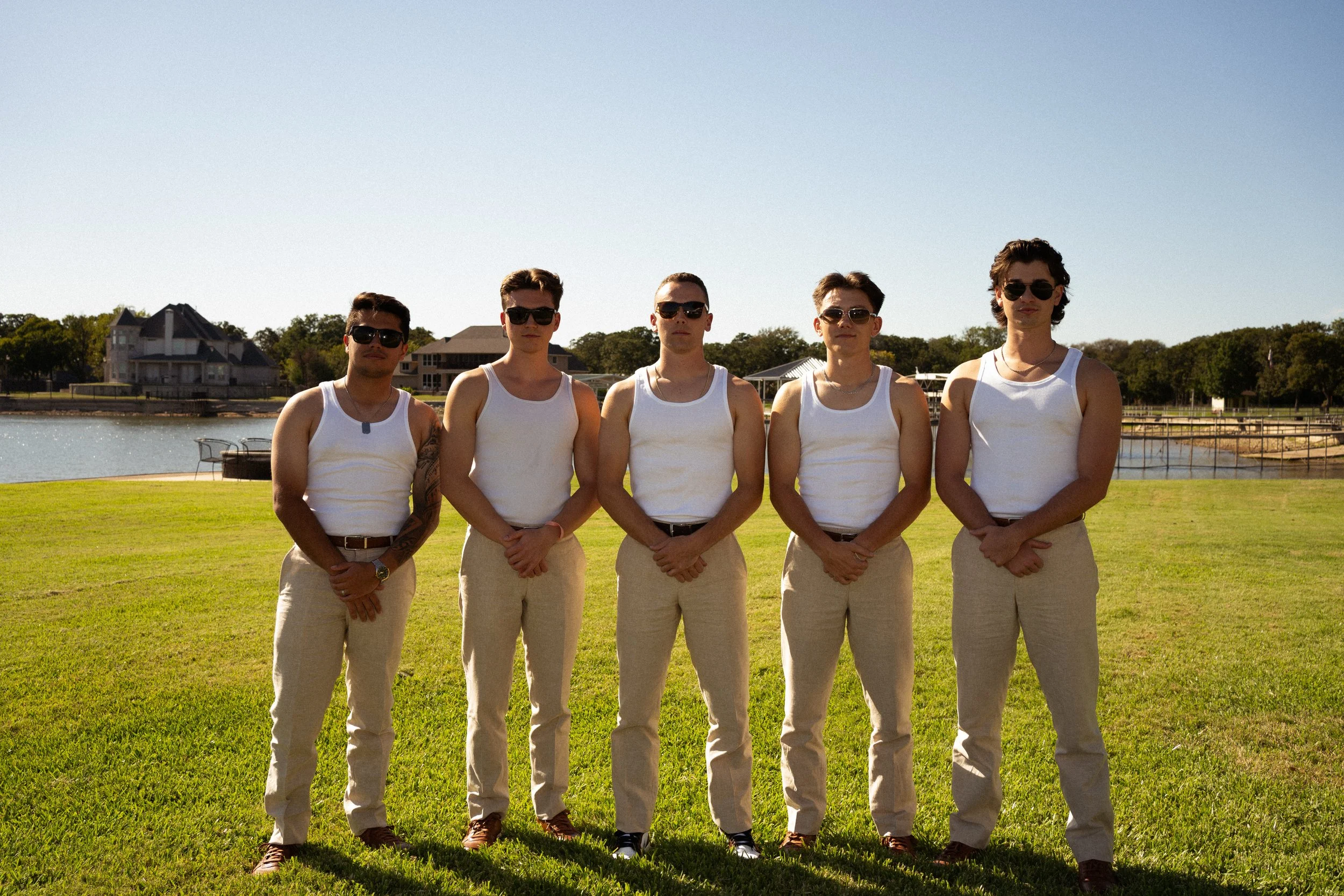 Groomsmen standing together during a backyard wedding celebration in Fort Worth, Texas.