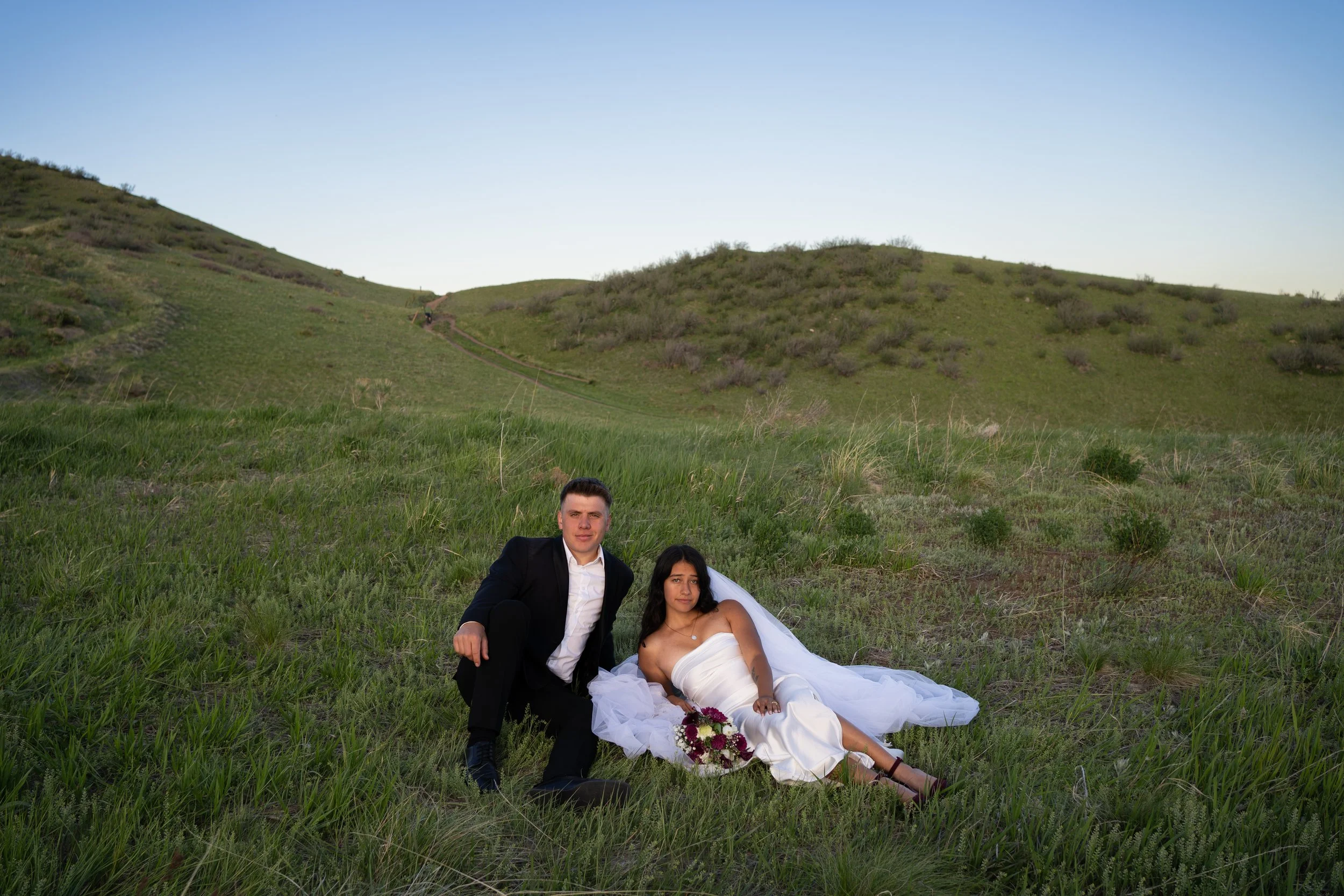 A relaxed and romantic portrait in Boulder, Colorado, capturing stillness and connection within open hills.
