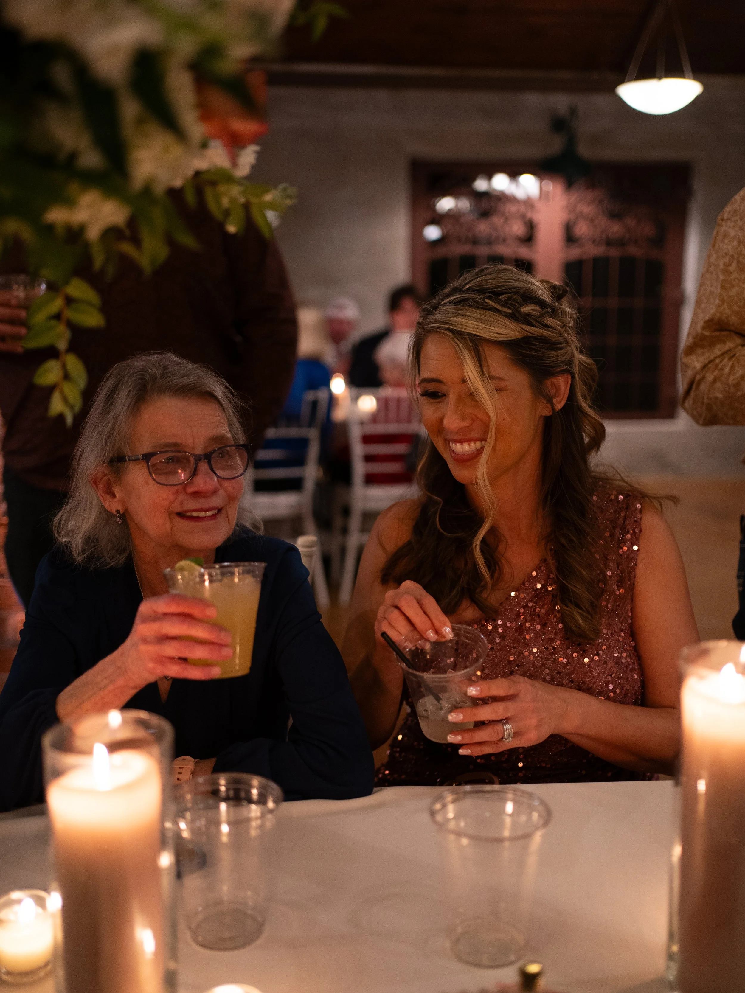 A warm, candid reception moment in Montgomery, TX, capturing genuine laughter and connection shared among guests during the celebration.