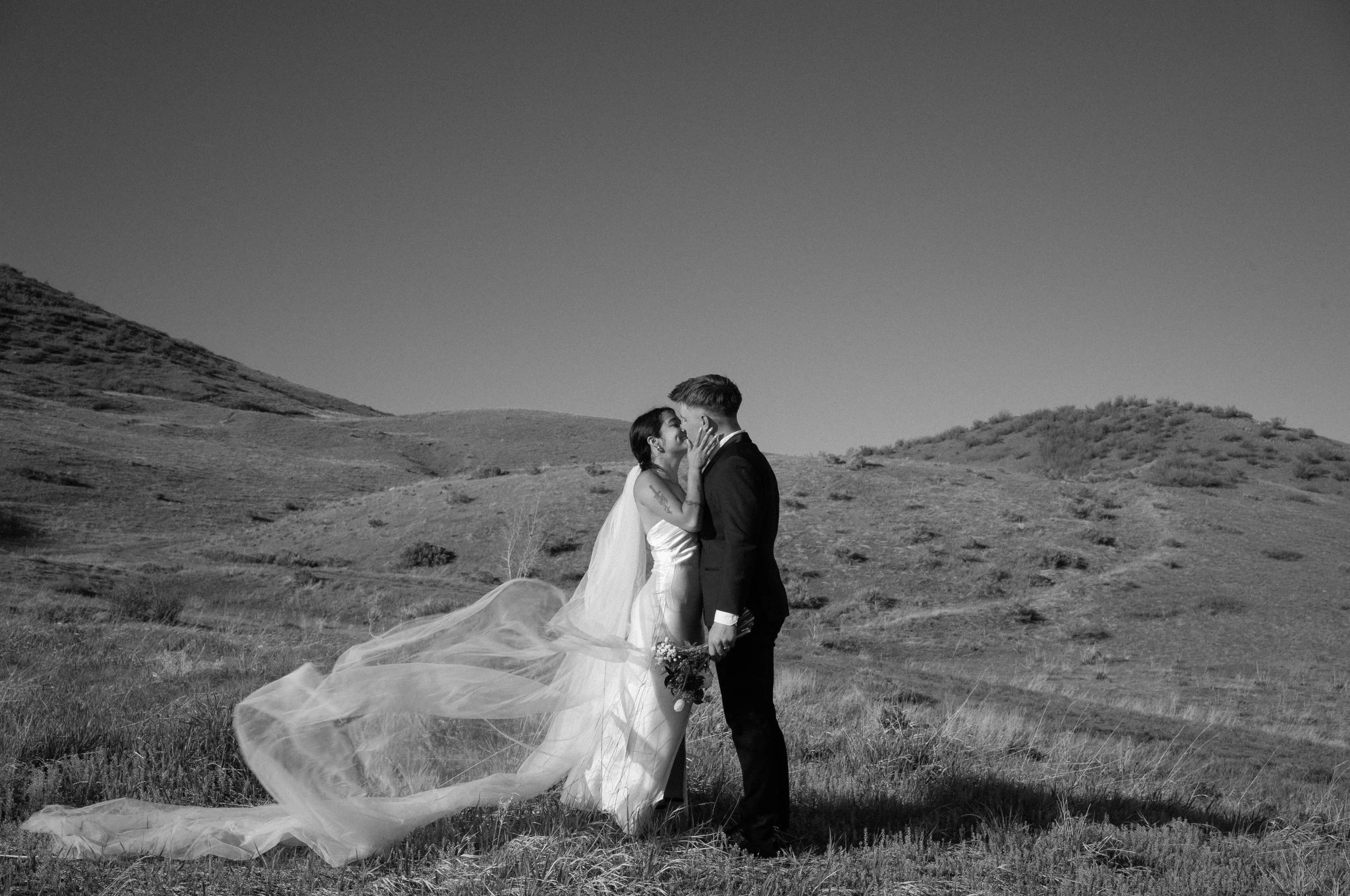 A romantic black-and-white moment in Boulder, CO, capturing movement and intimacy in the open hills.