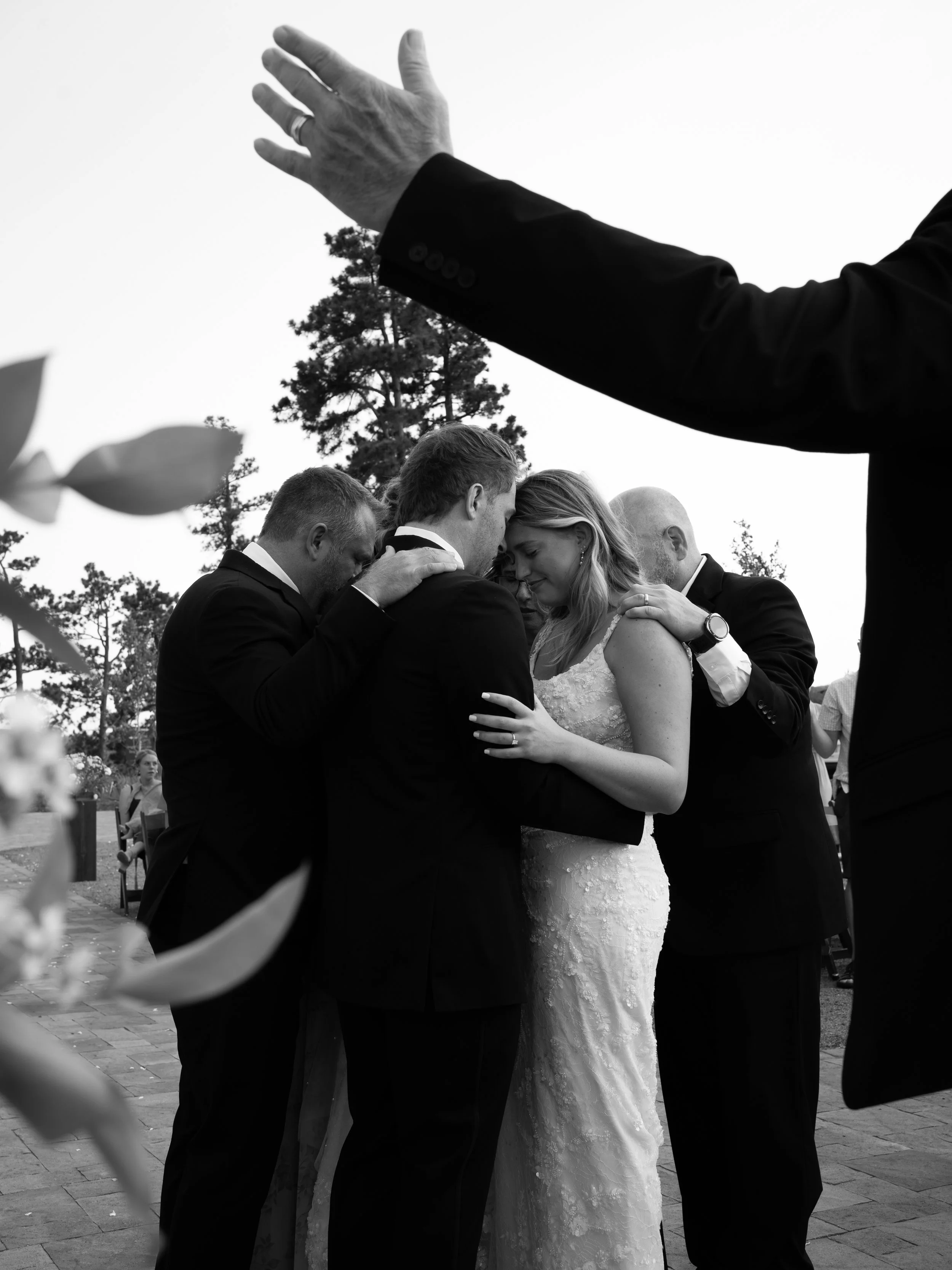 An emotional black-and-white moment at Pikes Peak Ranch, capturing connection and celebration among close family and friends.