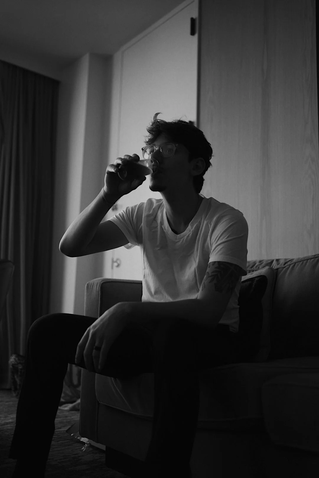 A quiet, contemplative portrait of the groom in Houston, Texas, captured in natural light with a minimalist, documentary approach.