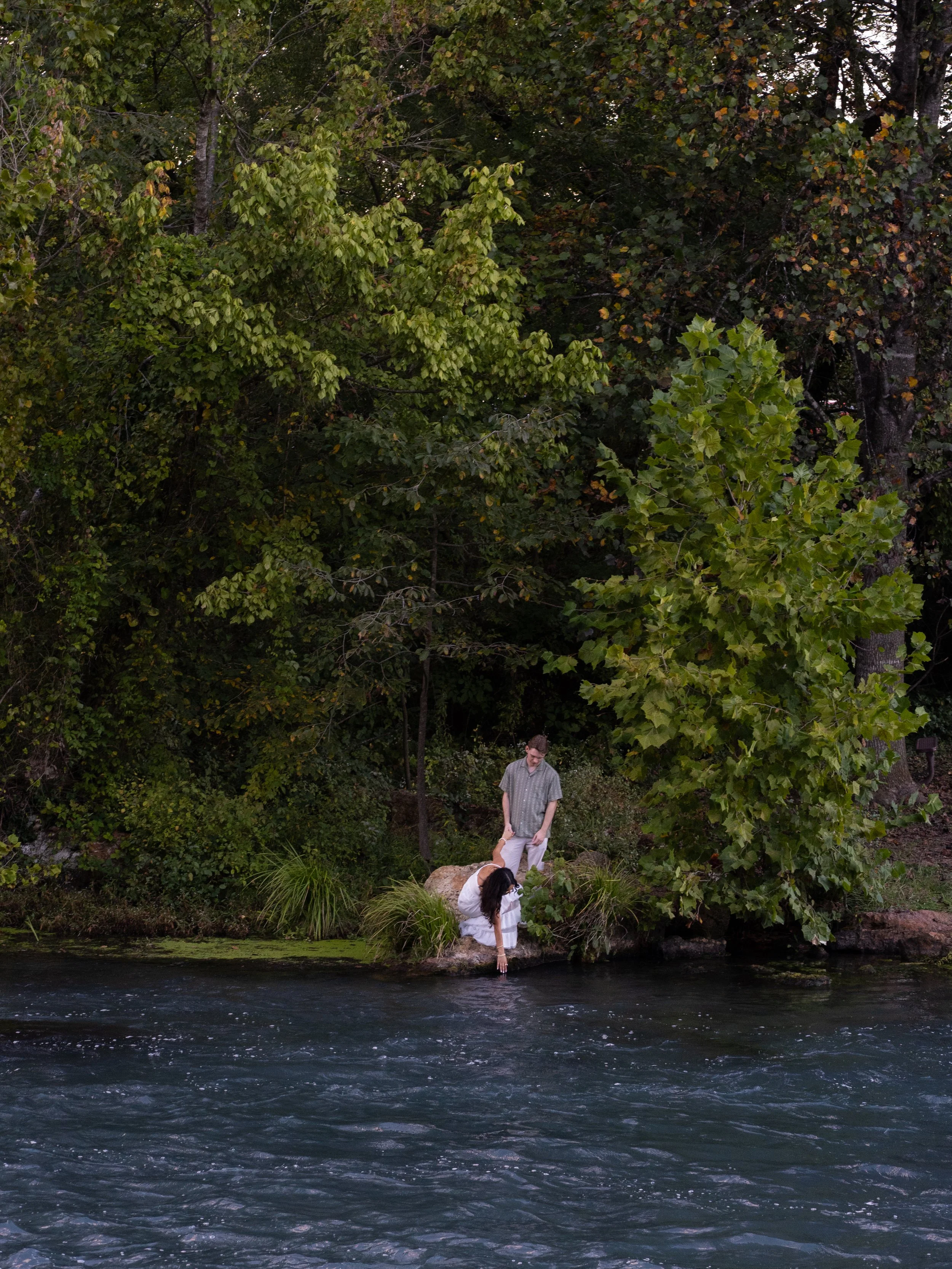 A peaceful riverside moment in Mammoth Spring, Arkansas, capturing the couple surrounded by nature and stillness.