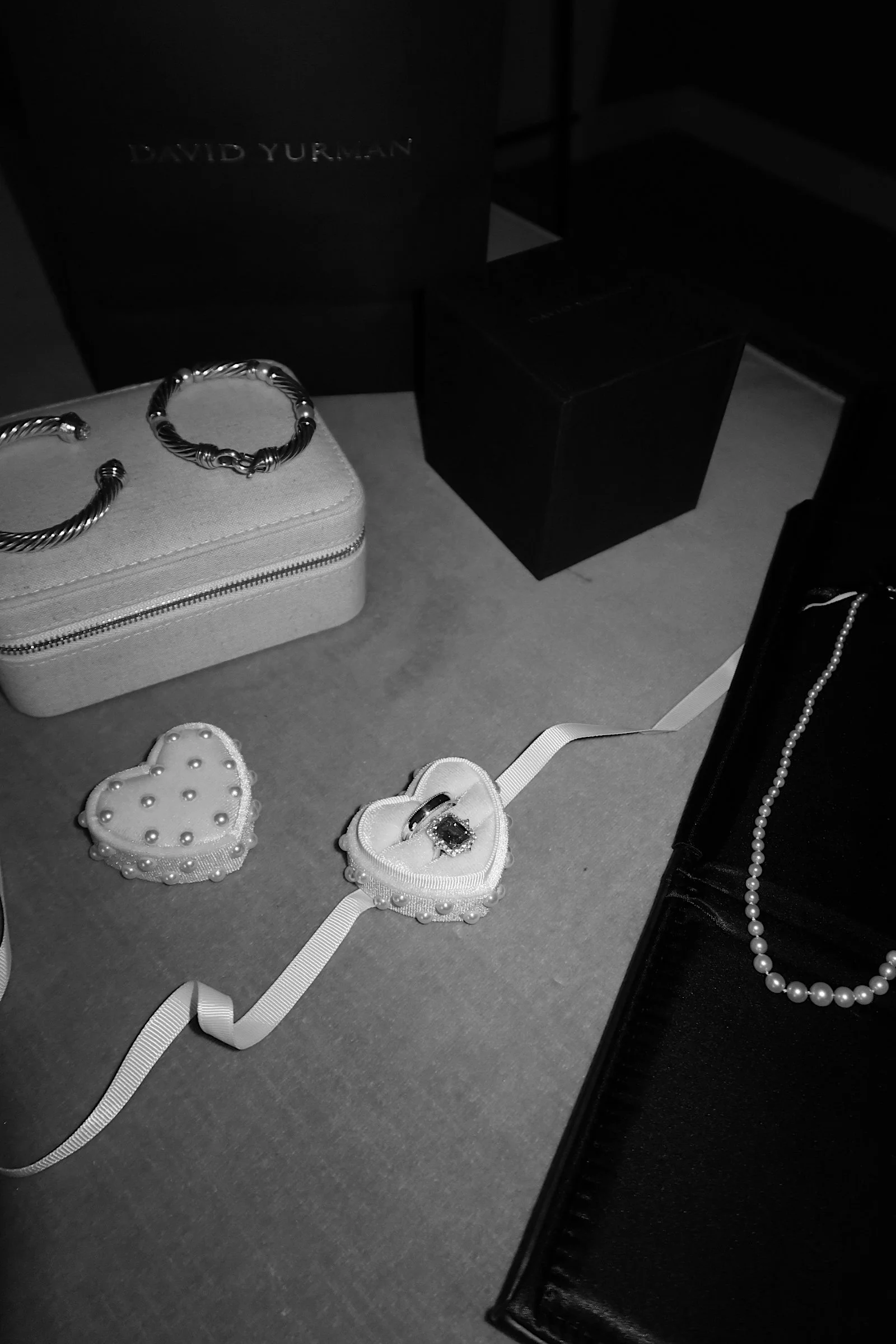 A minimalist black-and-white flat lay of bridal accessories in Houston, TX, highlighting timeless details with an editorial approach.