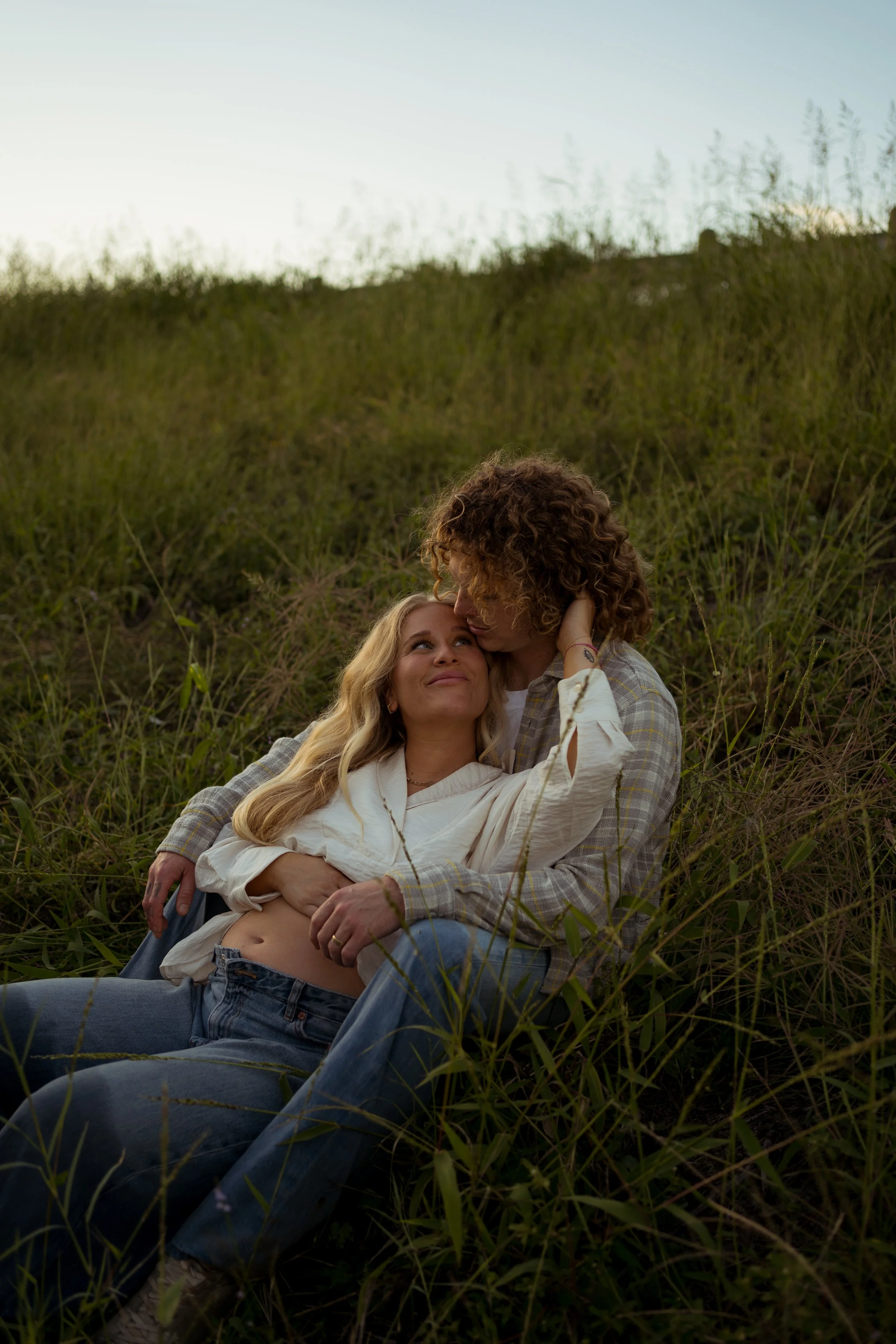 A soft and romantic portrait in Rainbow, TX, capturing quiet connection and warmth in golden evening light.