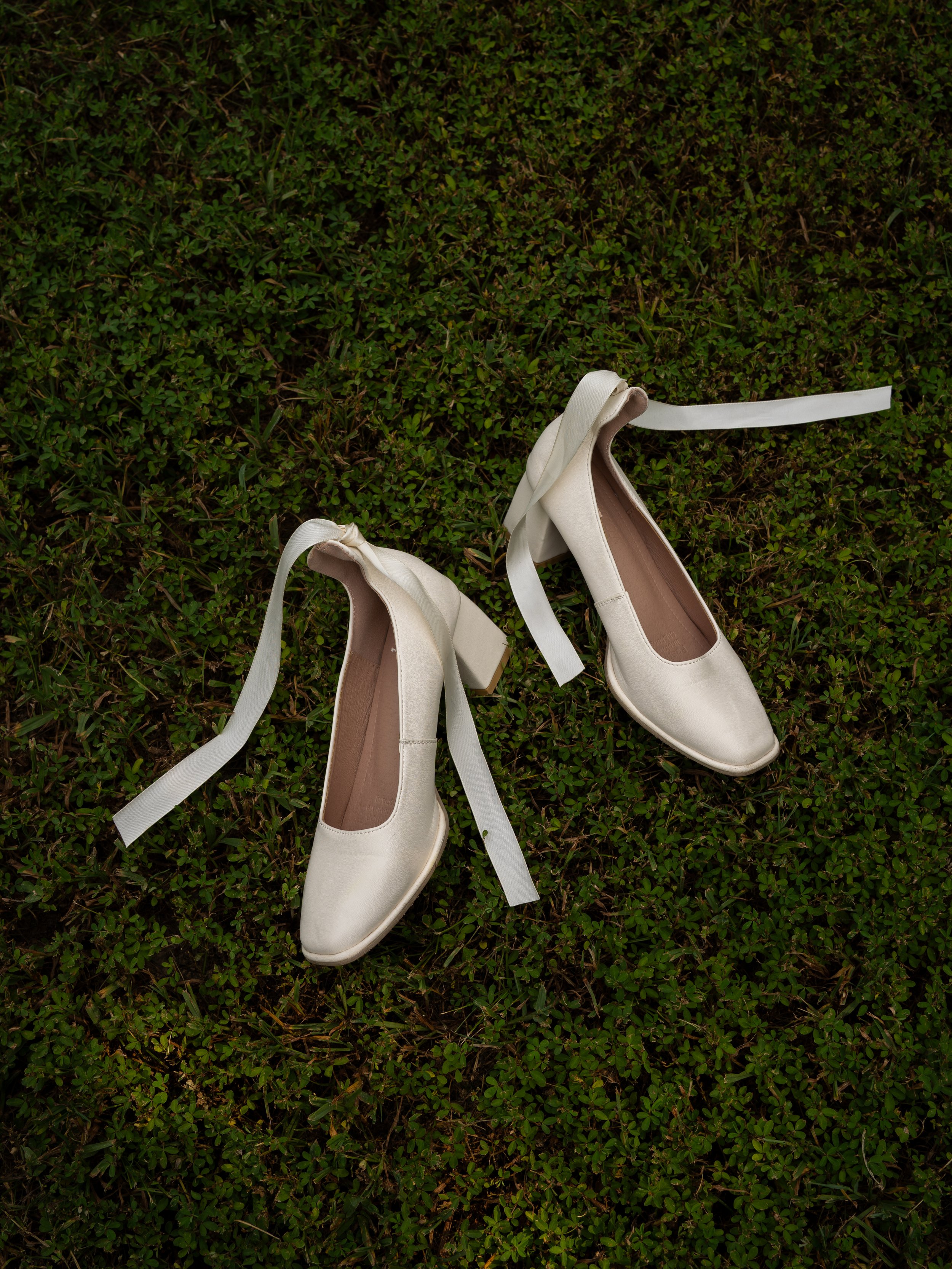 A soft bridal detail in O’Fallon, MO, featuring classic shoes styled against natural textures.