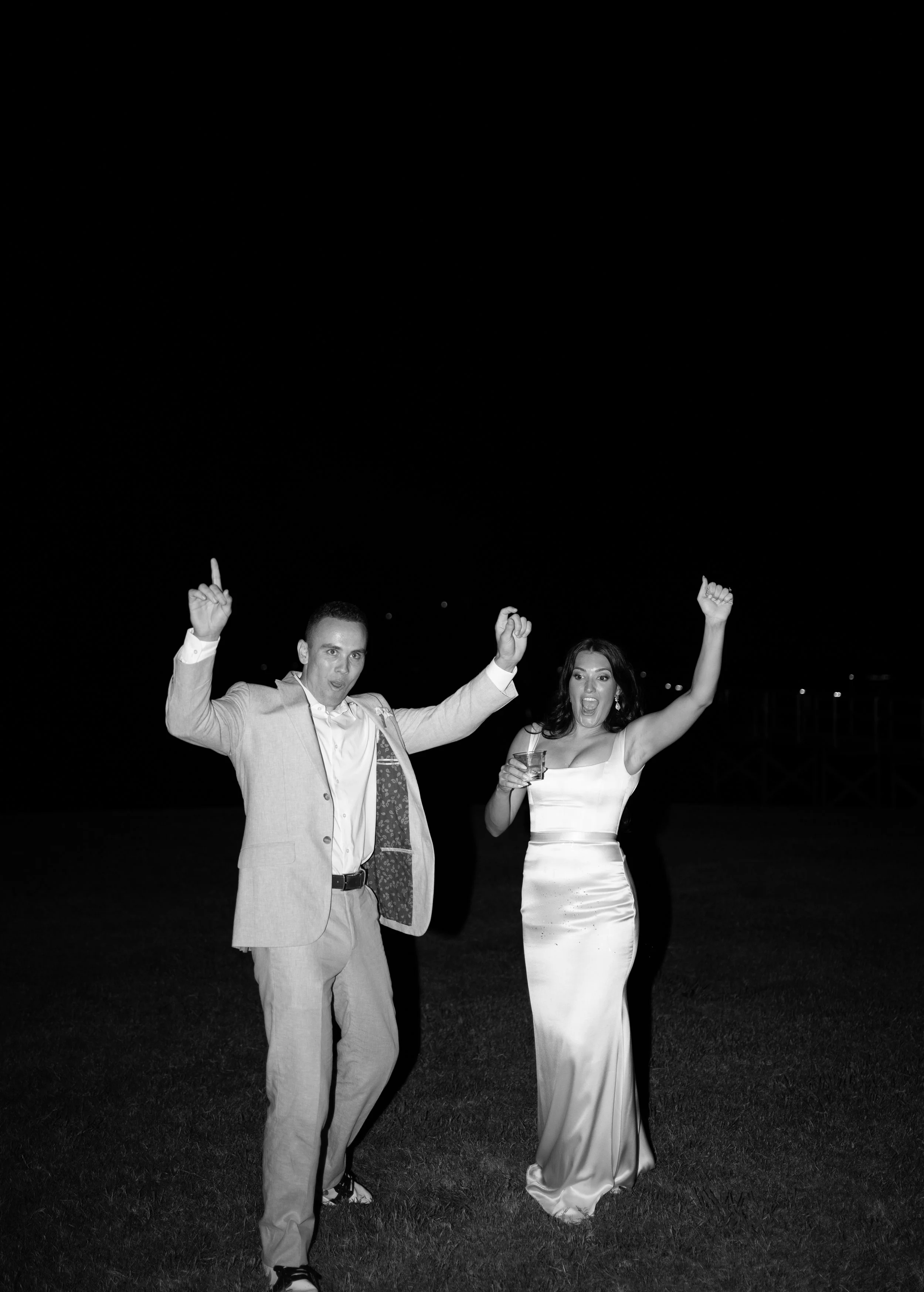Candid black and white reception moment capturing celebration and movement at a Fort Worth wedding.