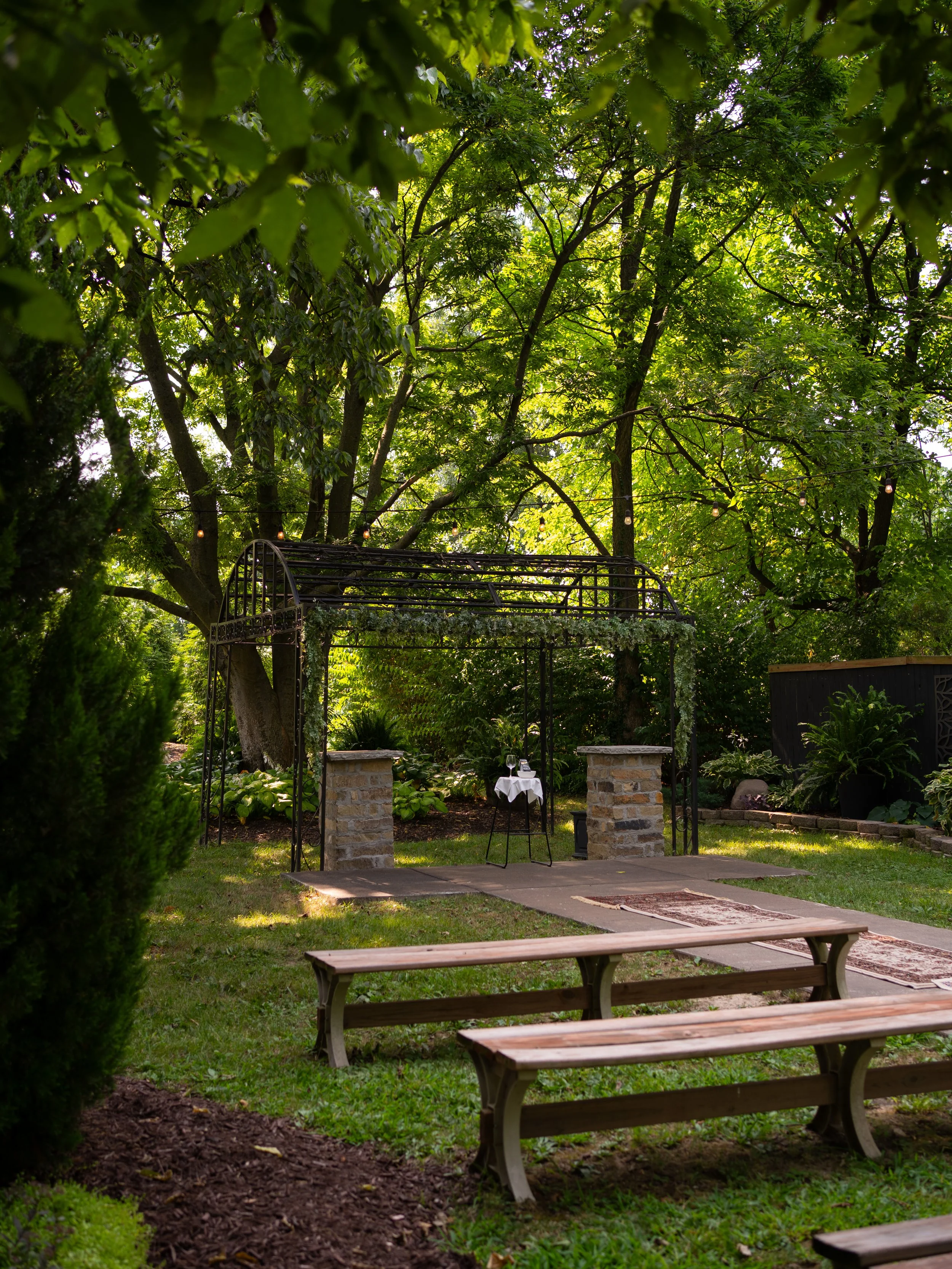 A peaceful garden ceremony setup in O’Fallon, Missouri, highlighting natural textures and intimate design.