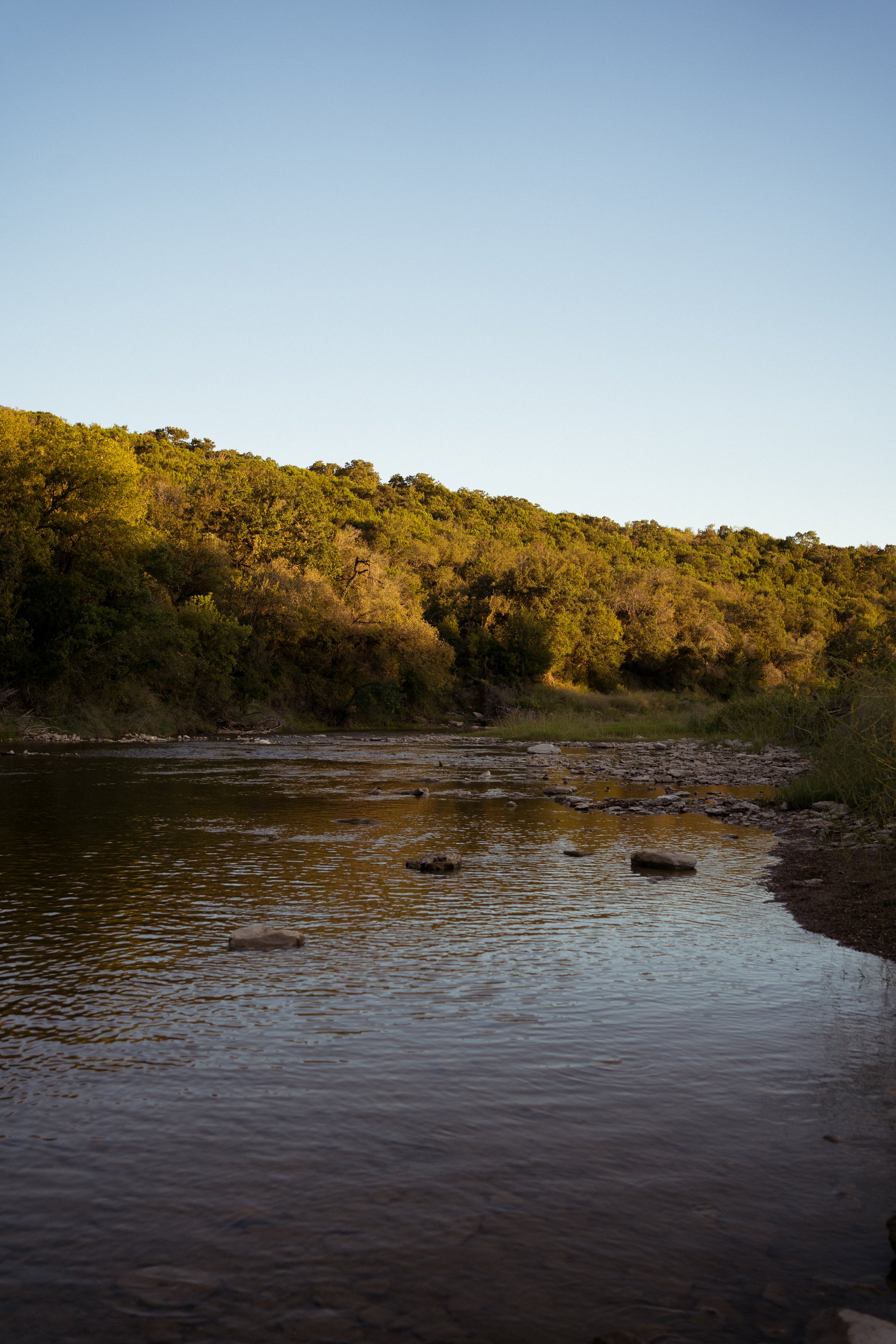 A peaceful river landscape in Rainbow, Texas, grounding the session in its natural surroundings.