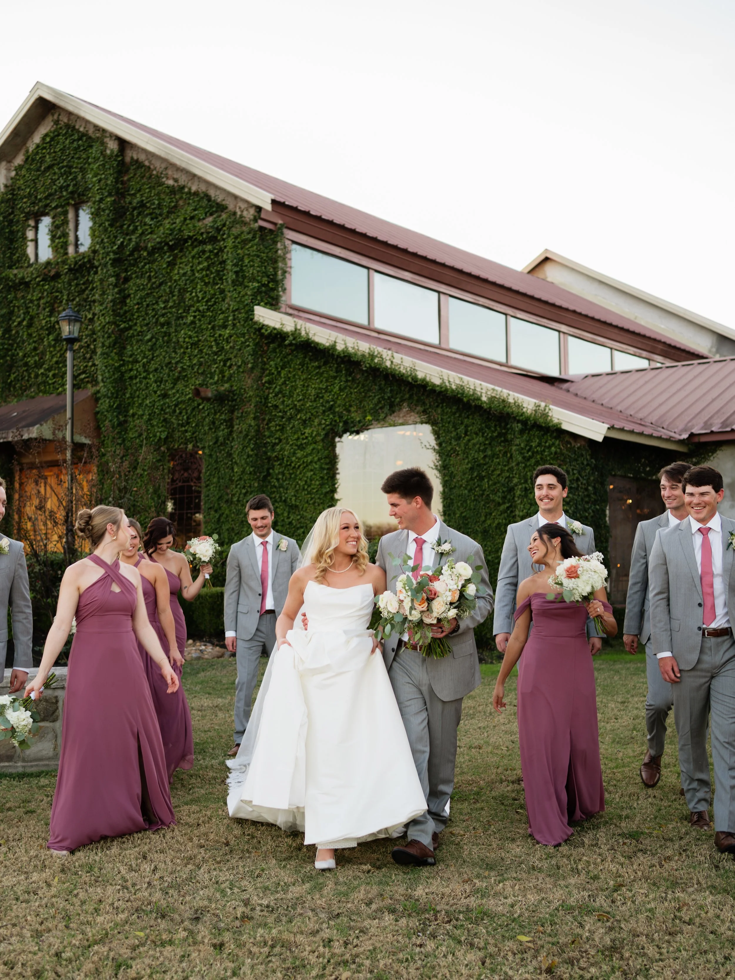 Wedding party outside the Olde Dobbin Station in Montgomery, Texas wedding venue captured with clean architectural lines, offering a timeless and sophisticated backdrop.
