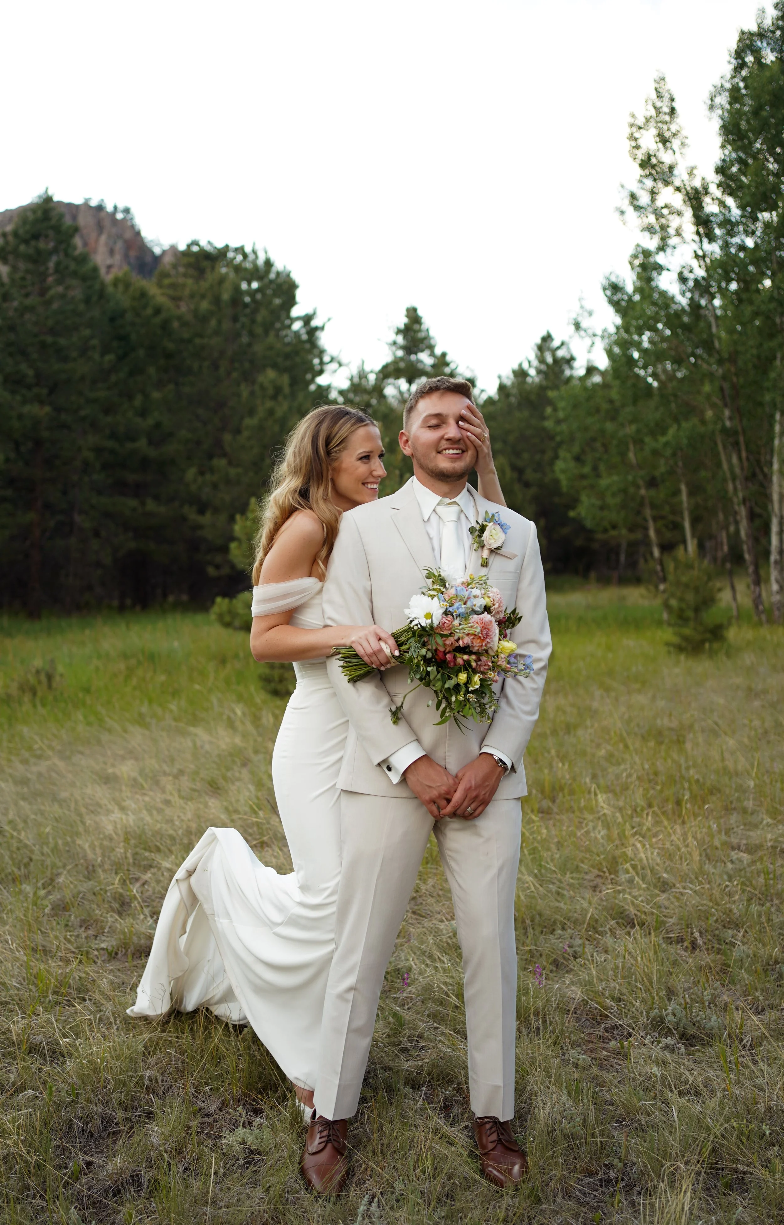 Bride and Groom portraits in grassy field in Pine, Colorado