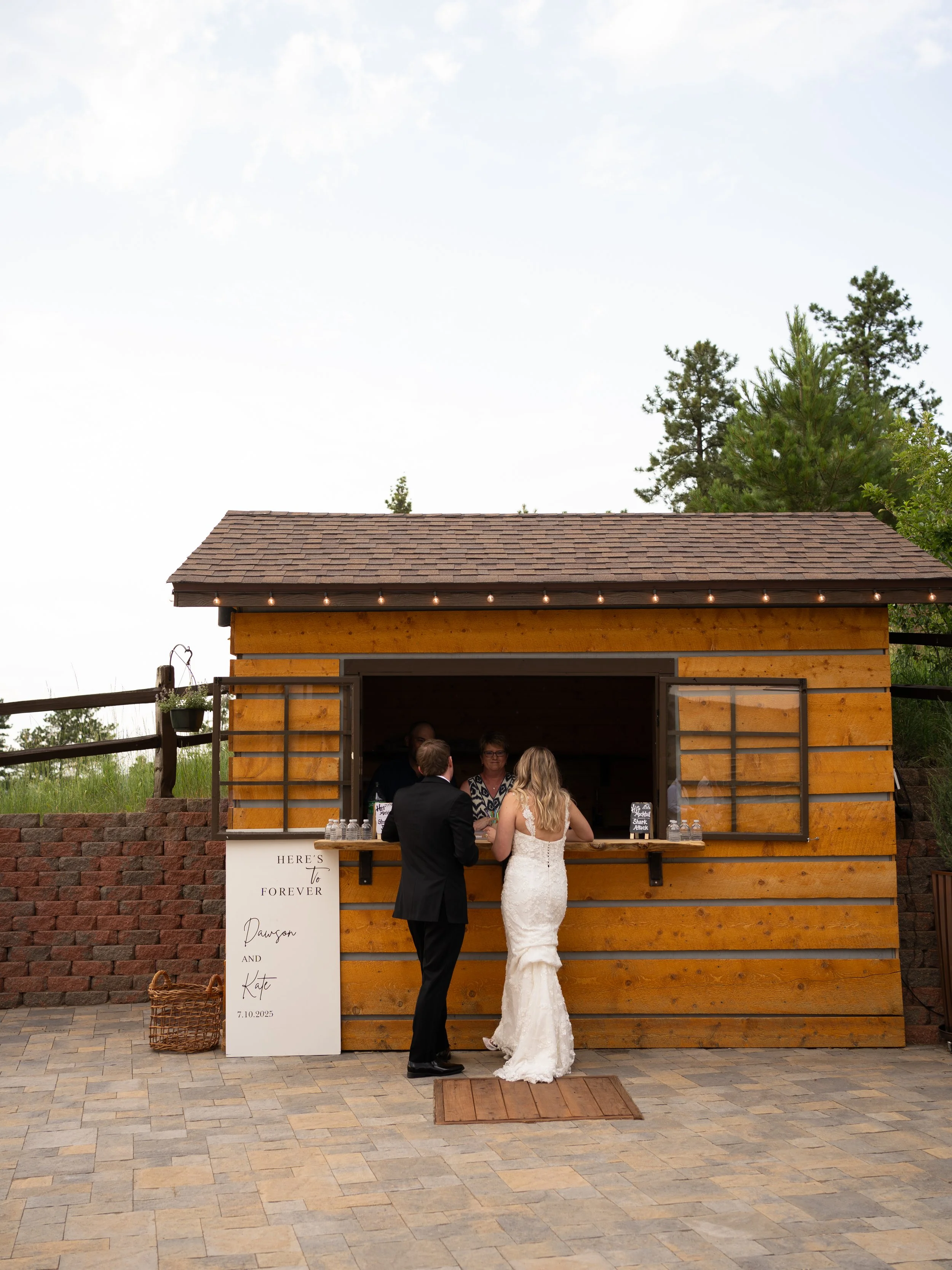 A relaxed and candid moment at Pikes Peak Ranch, capturing guests gathering at a rustic outdoor bar.