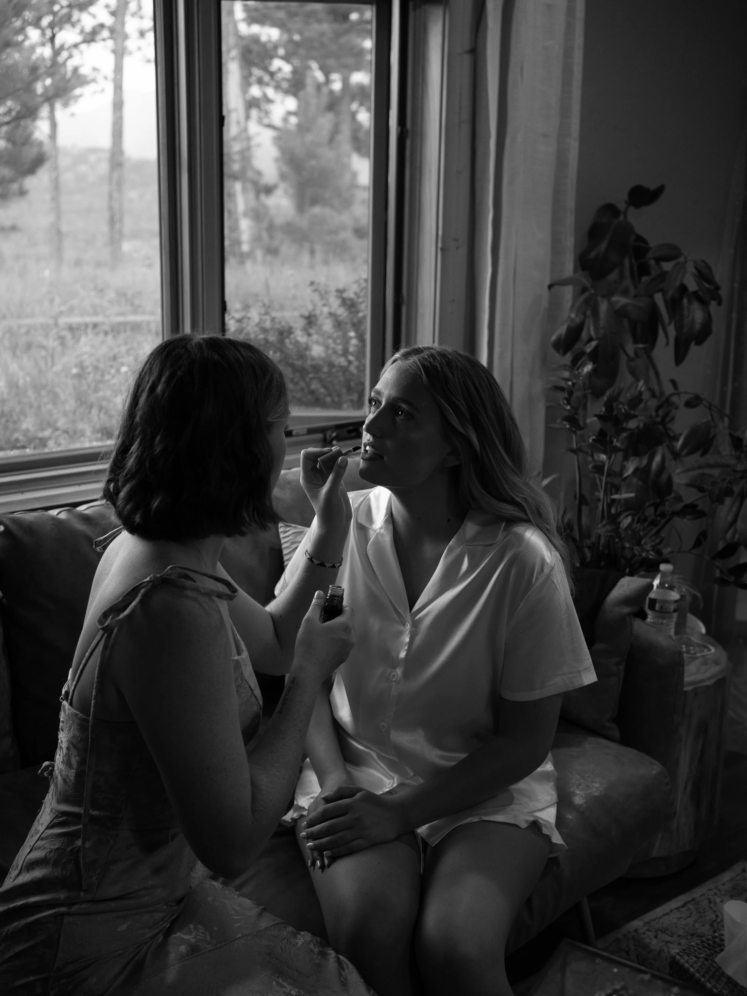 A soft, candid getting-ready moment in Woodland Park, Colorado, capturing connection and anticipation.