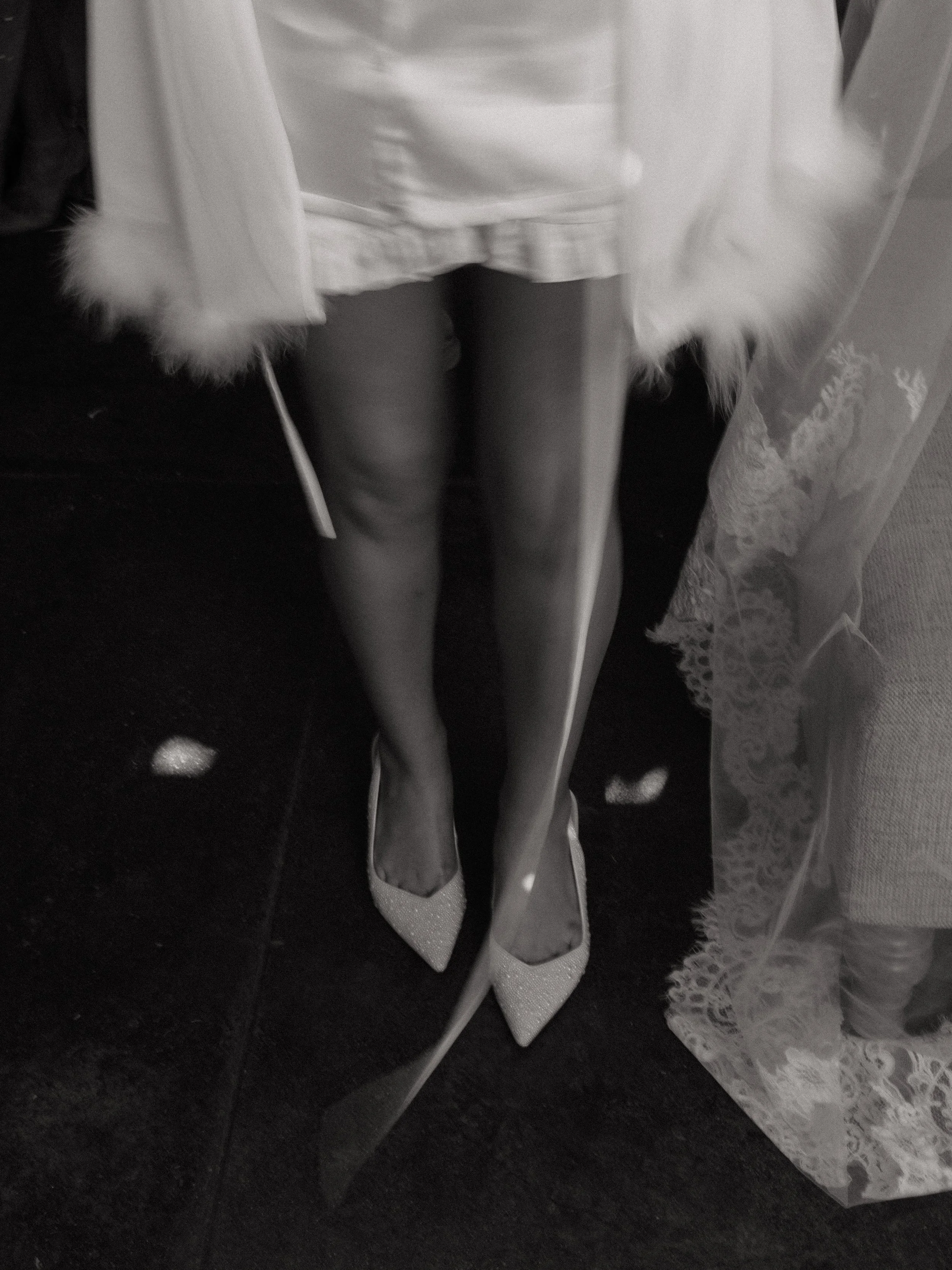 A minimalist black-and-white detail shot highlighting bridal textures and movement, captured with an editorial approach in Montgomery, Texas.