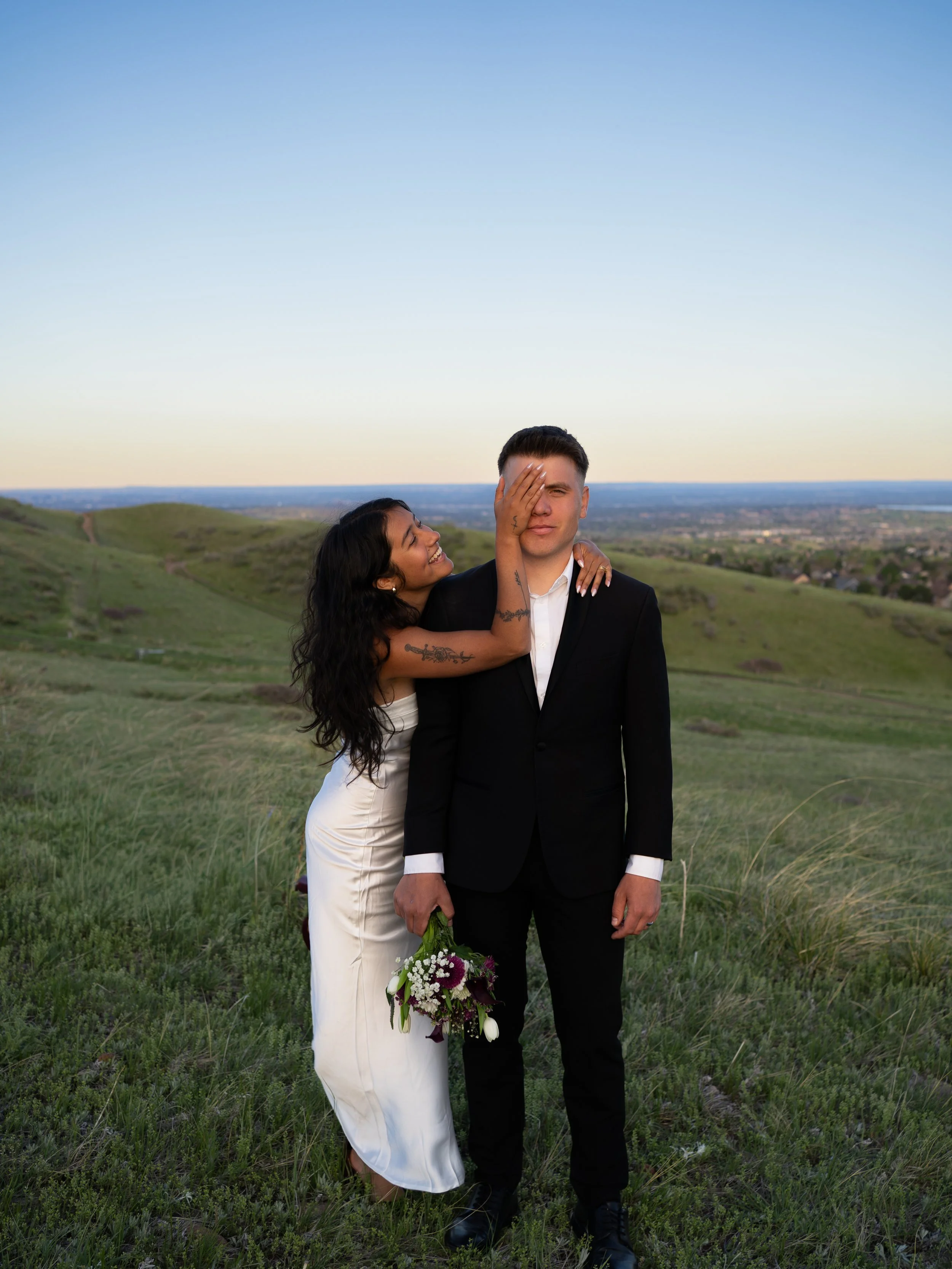 A soft golden-hour portrait in Boulder, Colorado, capturing connection and warmth against rolling hills.