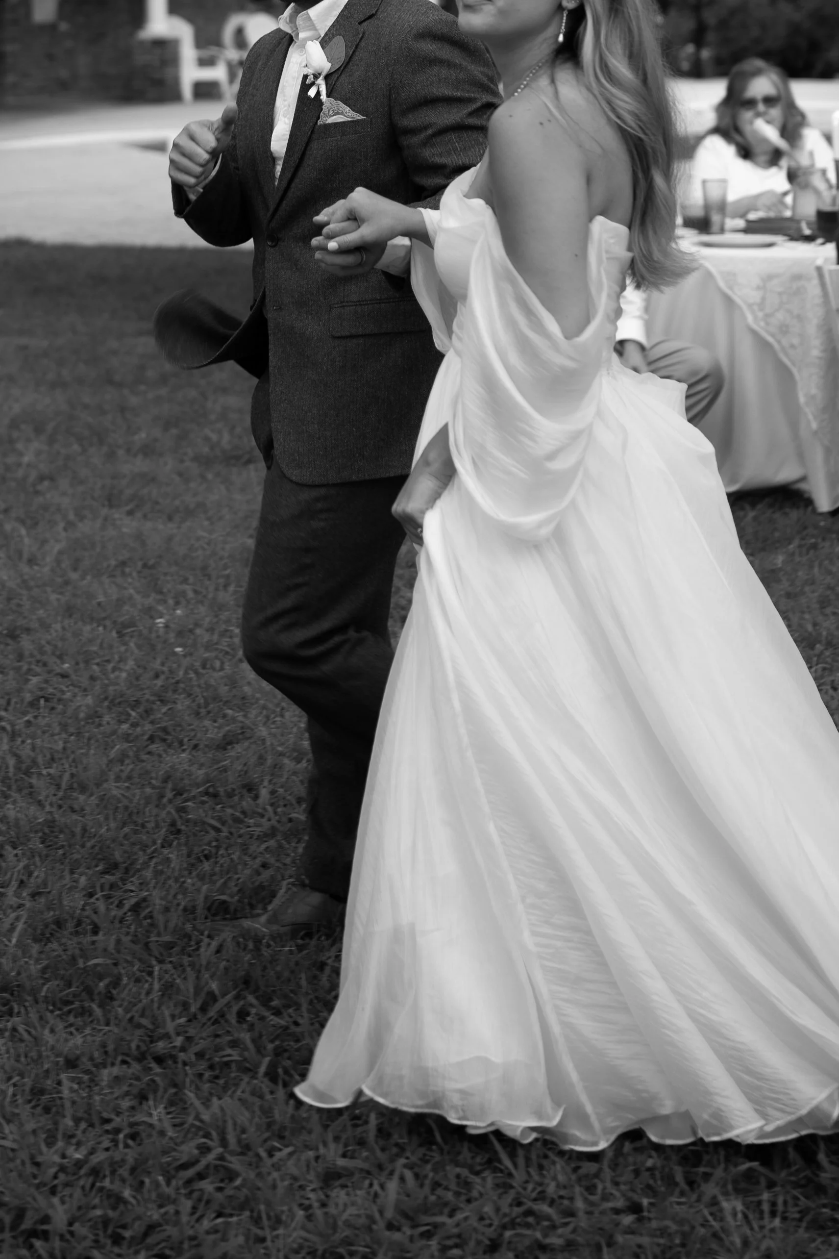 Candid, grand entrance of bride and groom at reception