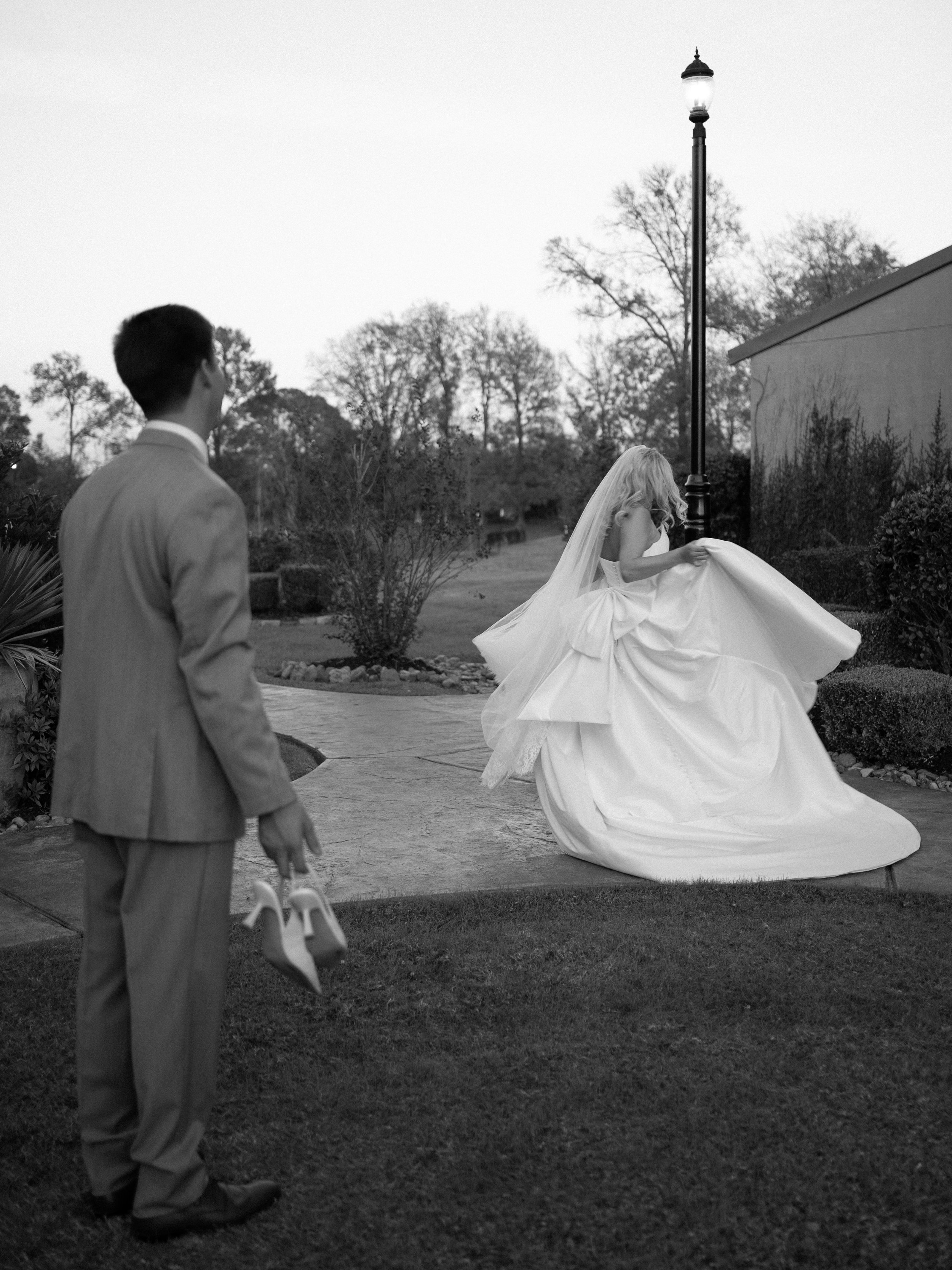 A quiet, emotional moment in Montgomery, TX, as the groom watches the bride move gracefully through the garden setting.
