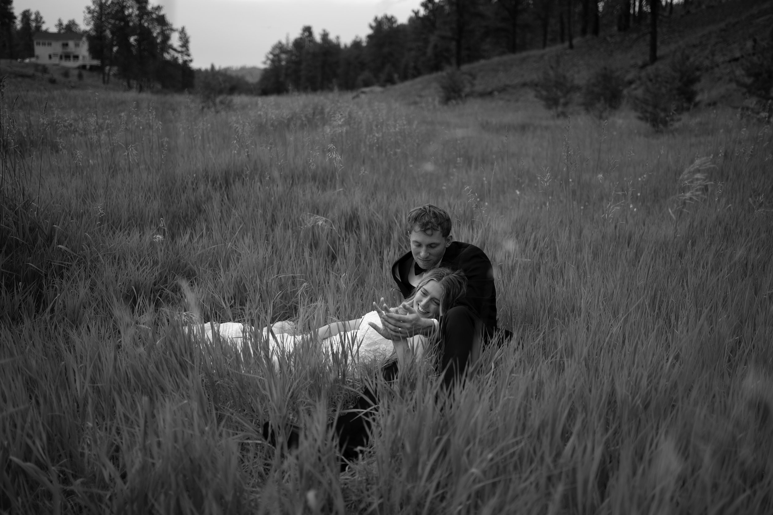 A peaceful black-and-white portrait in Woodland Park, CO, capturing intimacy within the surrounding landscape.