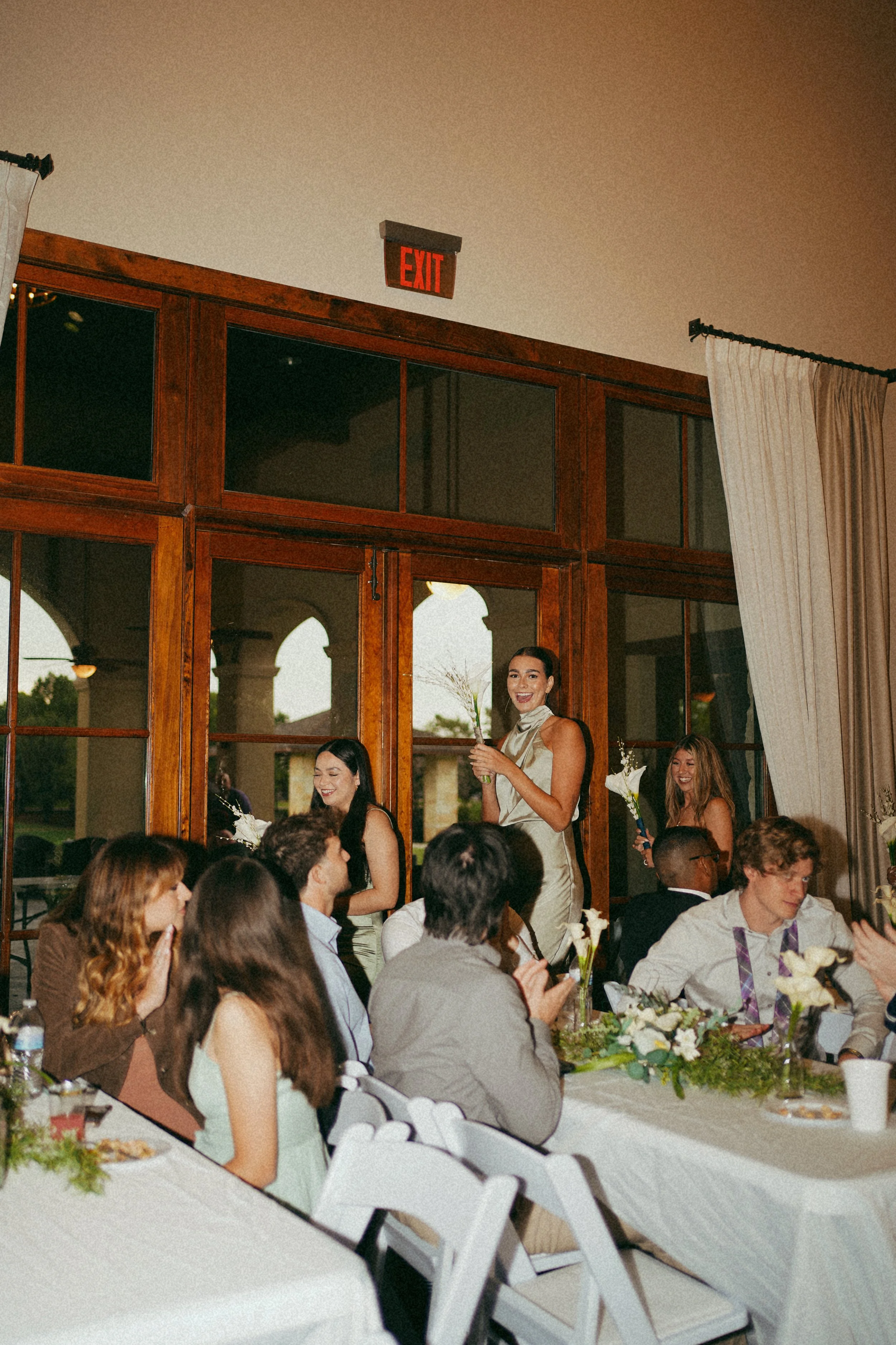 A candid reception moment in Richmond, TX, capturing connection and storytelling during the wedding party entrance 