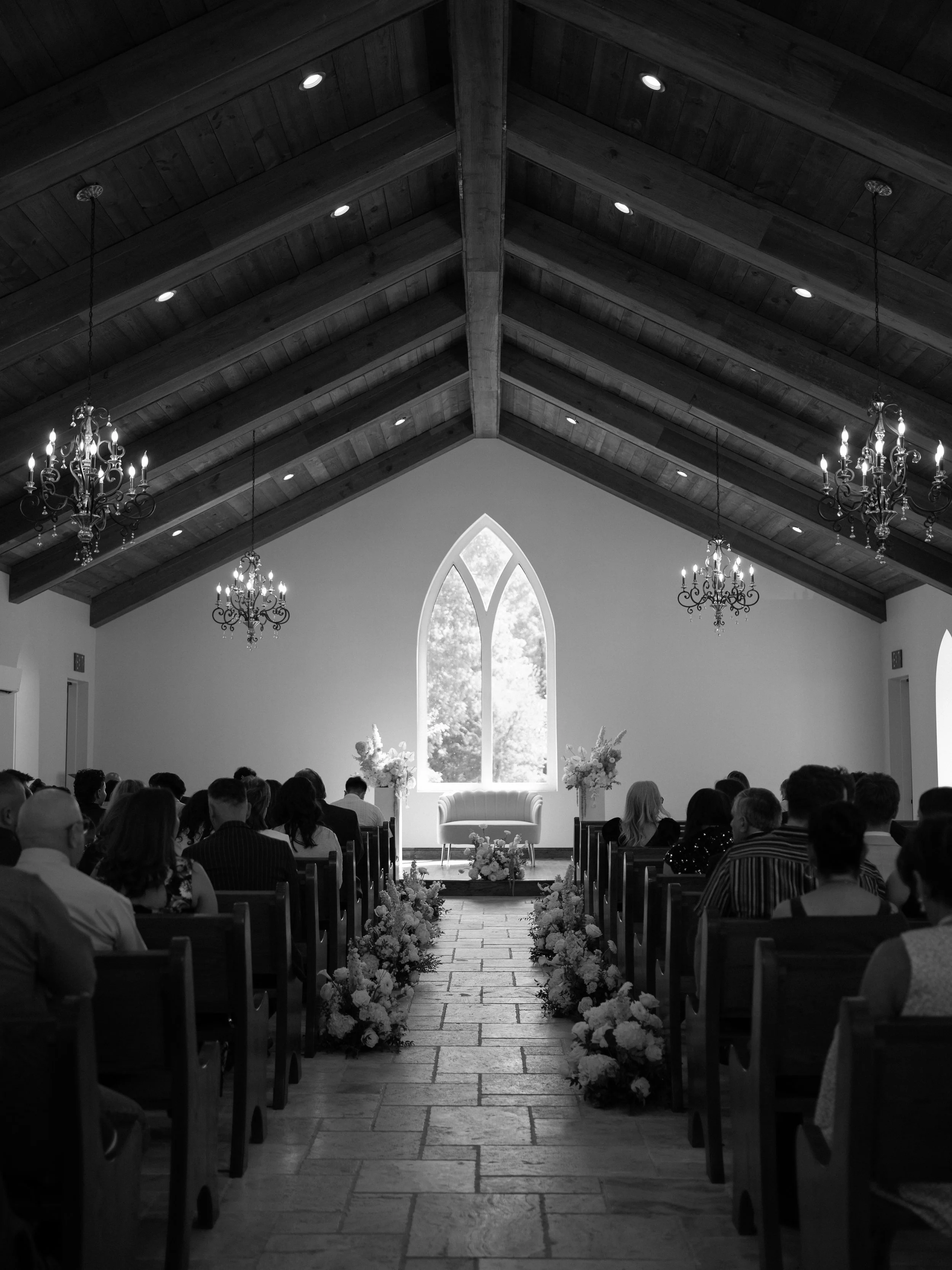 A classic black-and-white view of the ceremony in Waxahachie, TX, highlighting the grandeur and symmetry of the space.