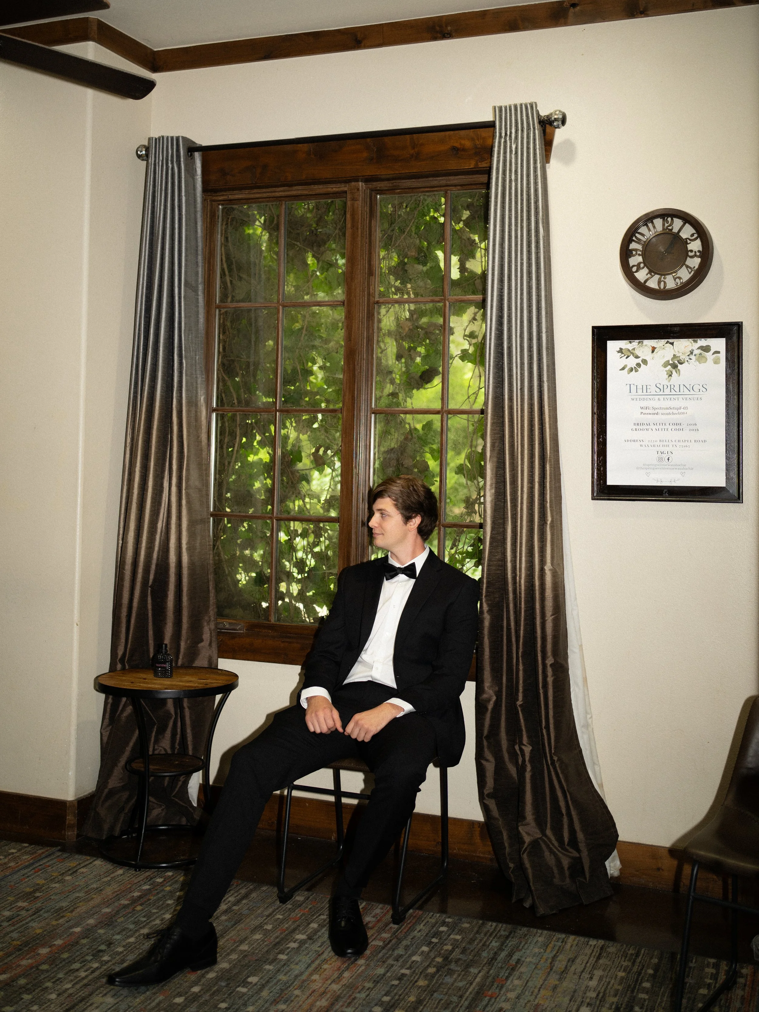 A classic groom portrait in Waxahachie, Texas, framed by natural window light and timeless interior details.