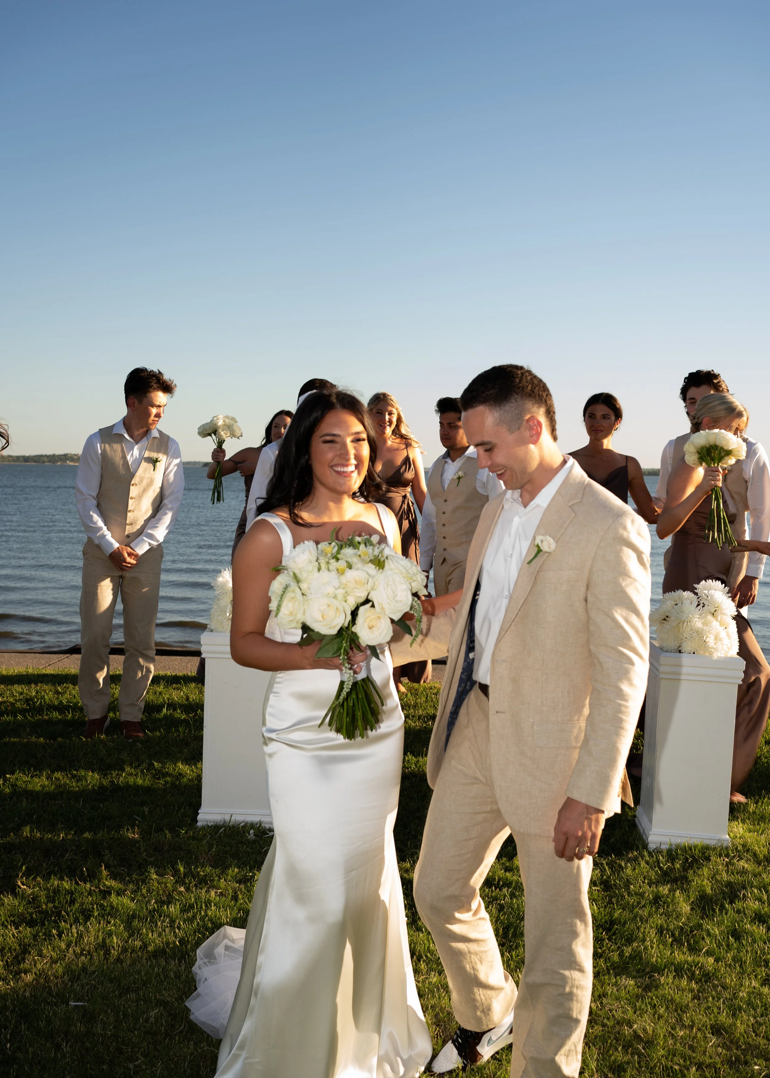 Bridal party walking together outdoors during a joyful backyard wedding in Fort Worth, Texas.