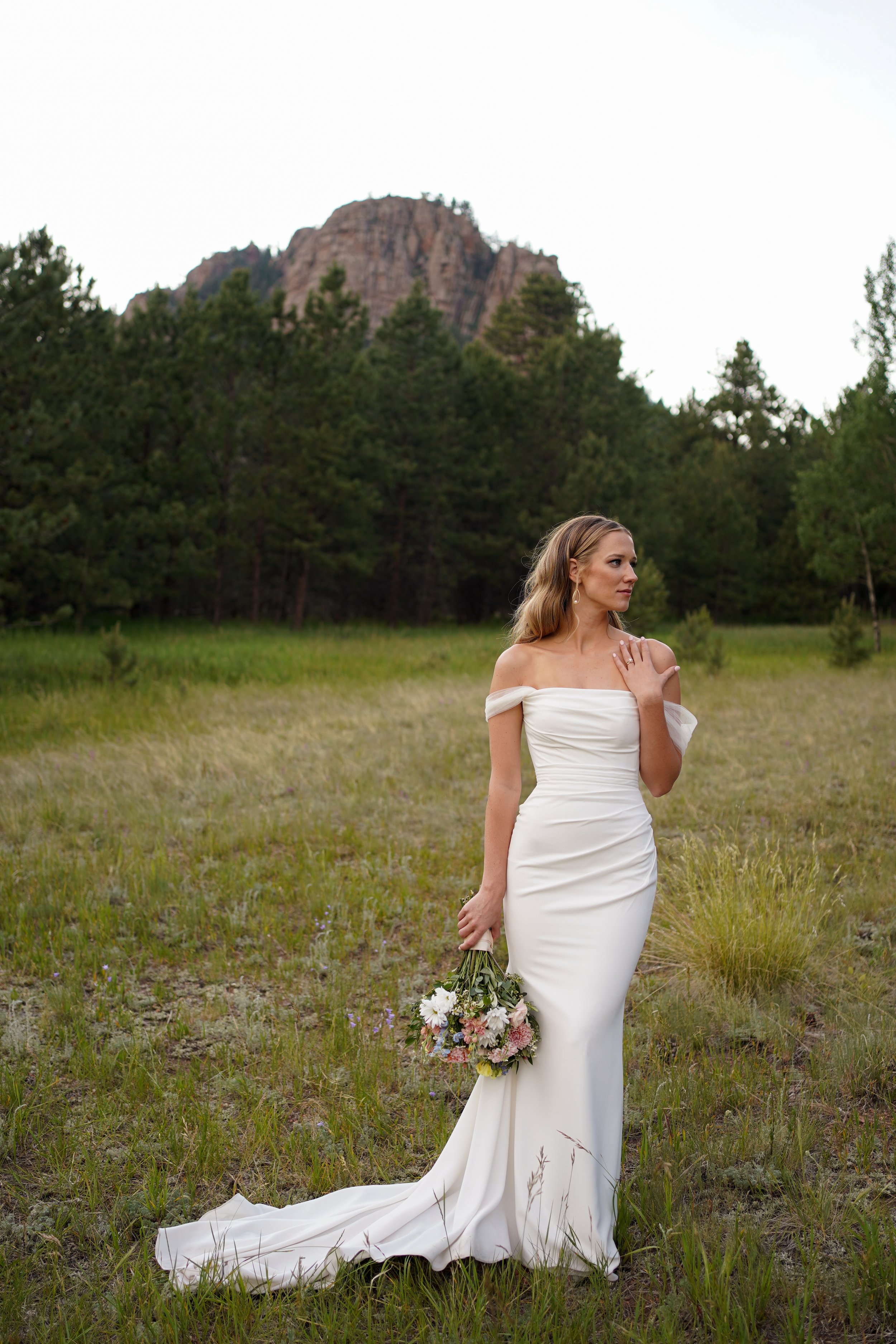 Bridal portraits in stunning dress in a Colorado field