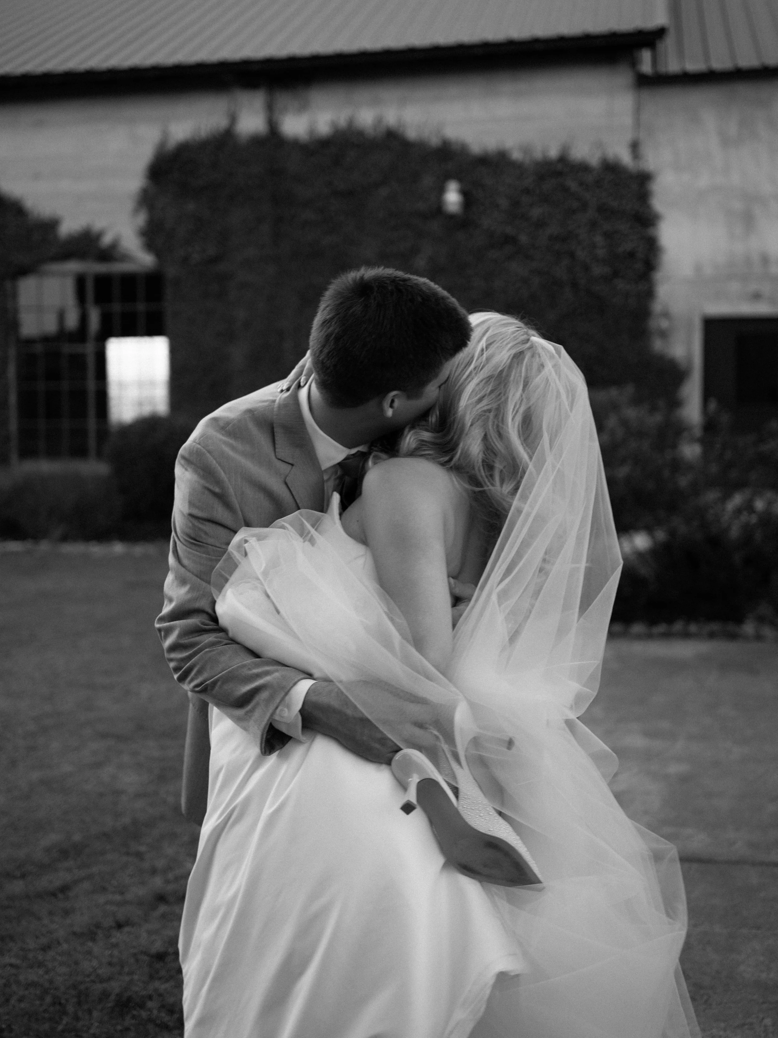 An emotional first look captured in Montgomery, Texas, as the couple shares a quiet embrace, preserving an intimate and heartfelt moment in black and white.