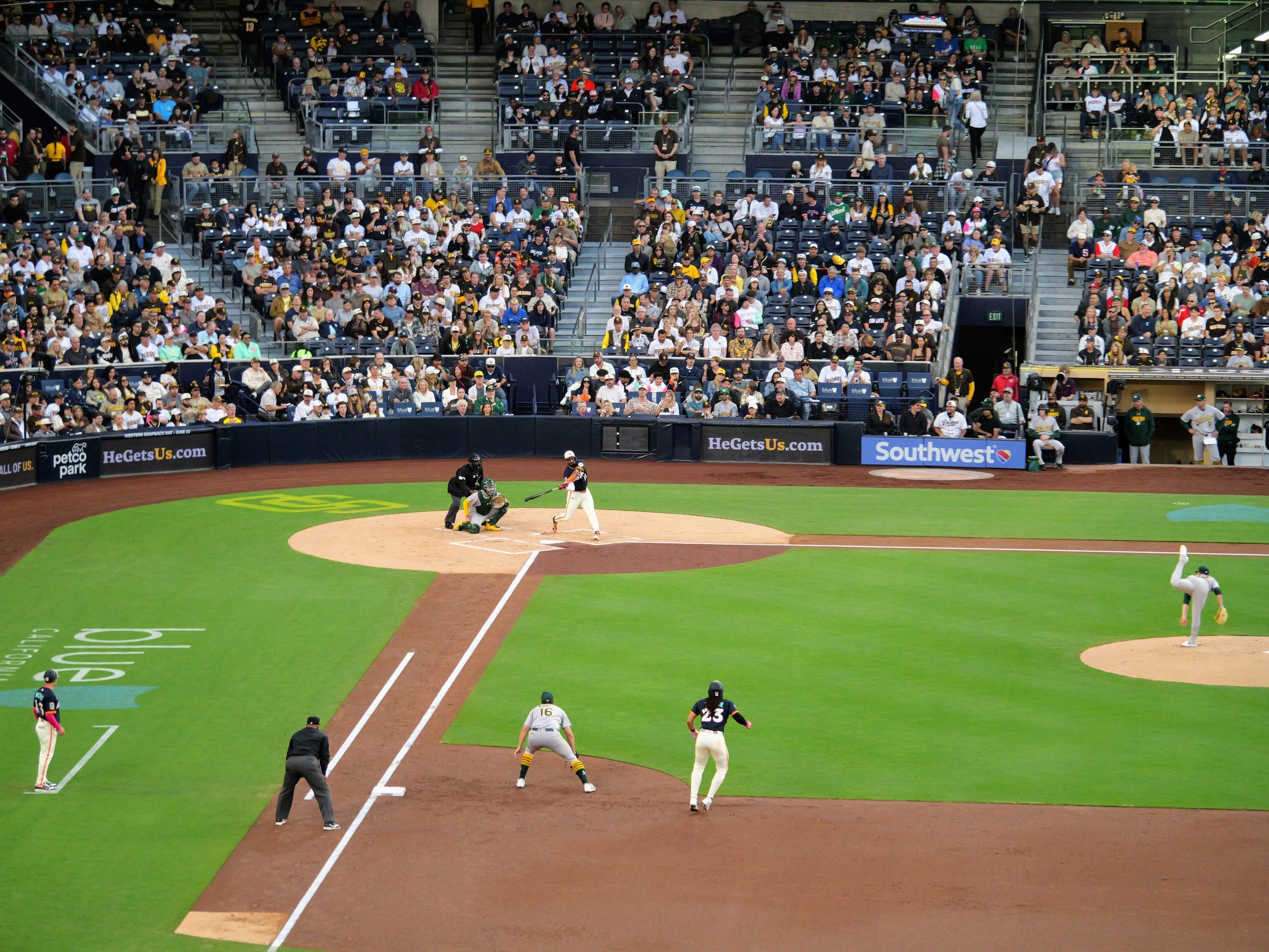 A baseball game in progress at Petco Park with players on the field and spectators in the stands.