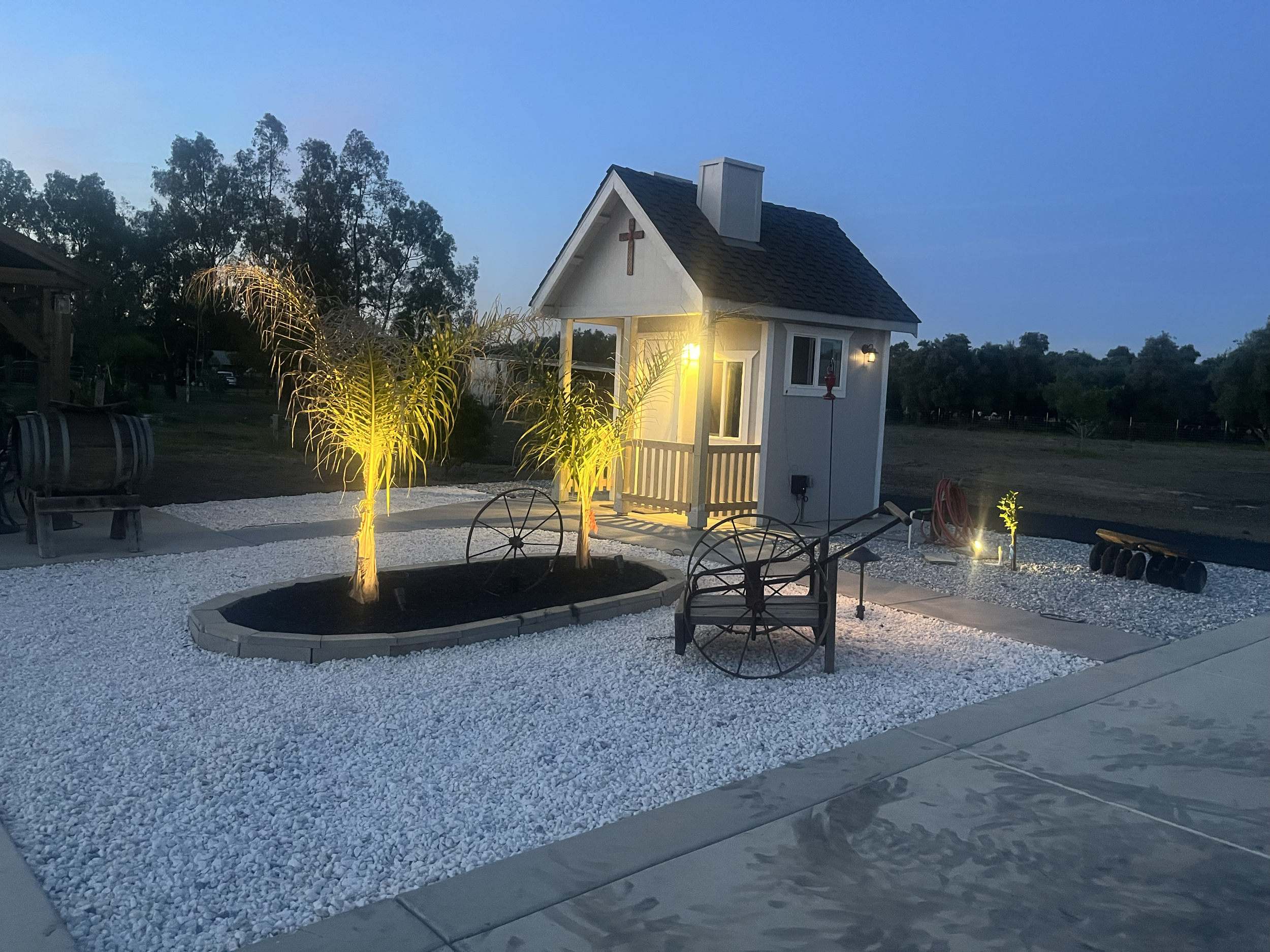 Updated outdoor space featuring decorative gravel, planter elements, and subtle lighting for a clean finished, look.