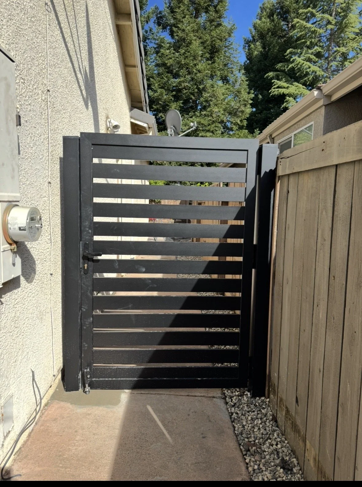 Upgraded side yard access with a modern metal gate for improved privacy and durability. Removed an older wood gate and installed a clean, low-maintenance metal option that enhances both security and curb appeal. Designed to fit the space seamlessly w