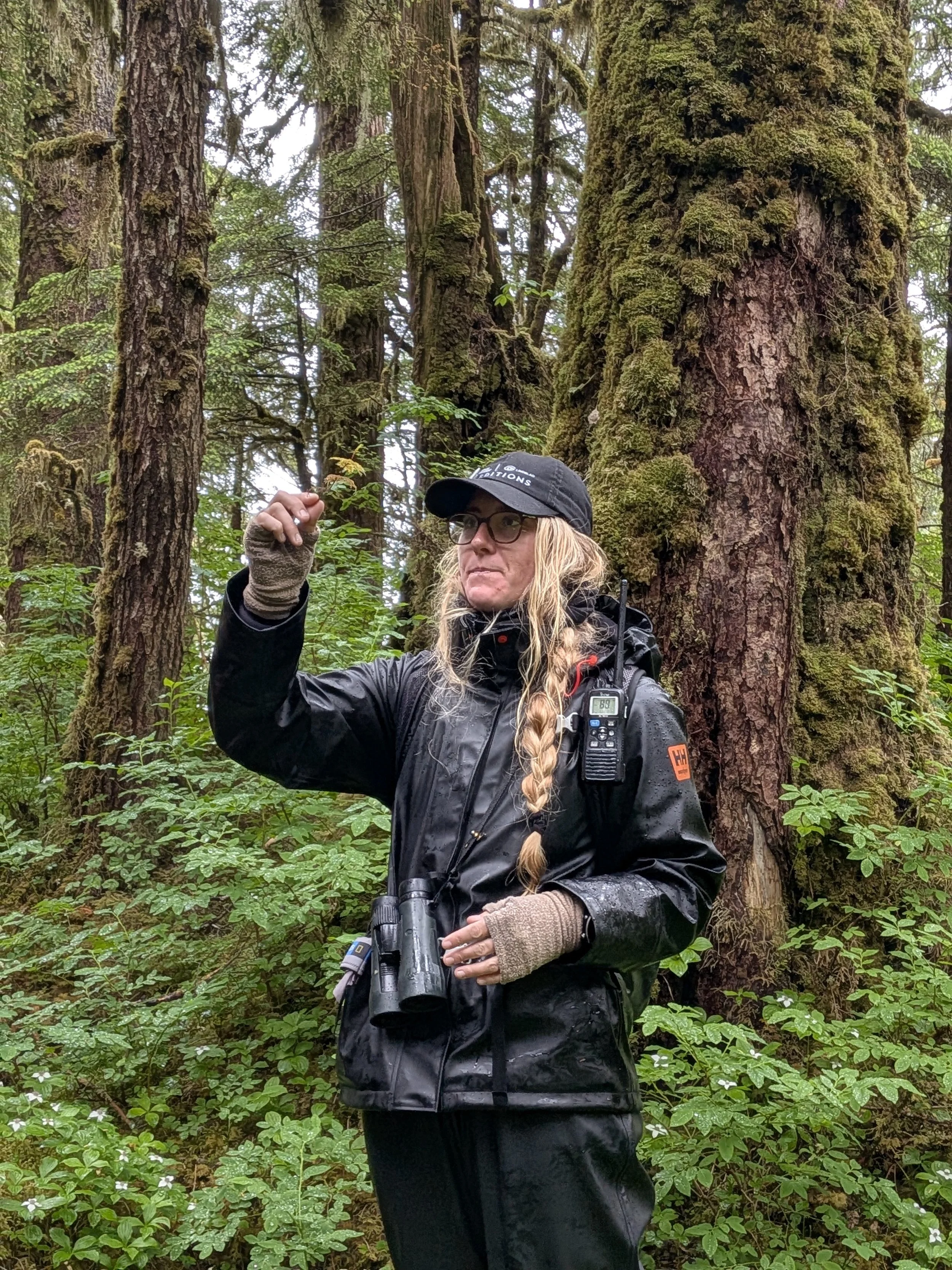 Naturalist explaining the connection between flora and fauna in the Alaskan ecosystem