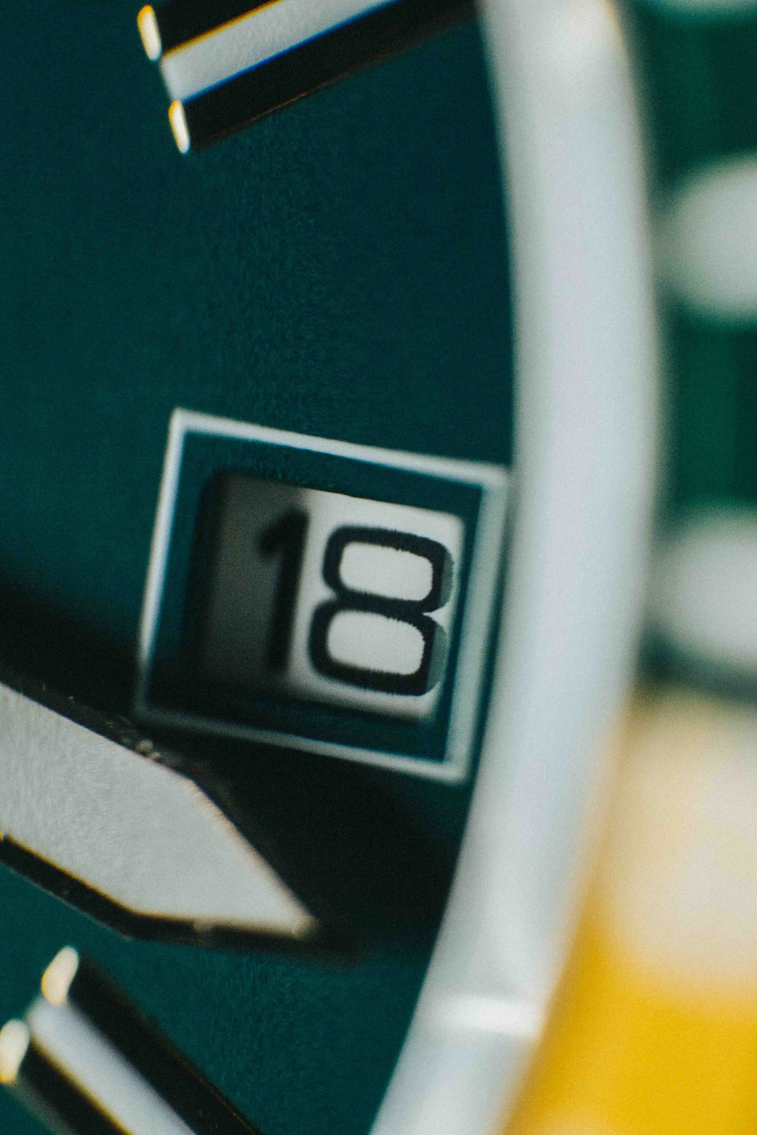 Close-up of a mechanical flip calendar showing the date "18".