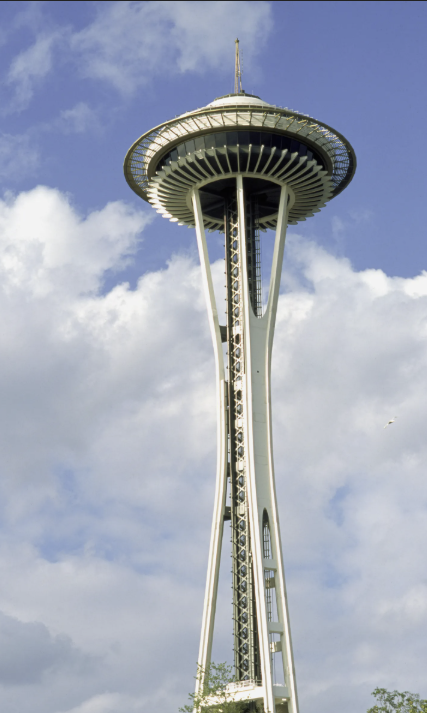 The Space Needle in Seattle, Washington, against a partly cloudy sky.