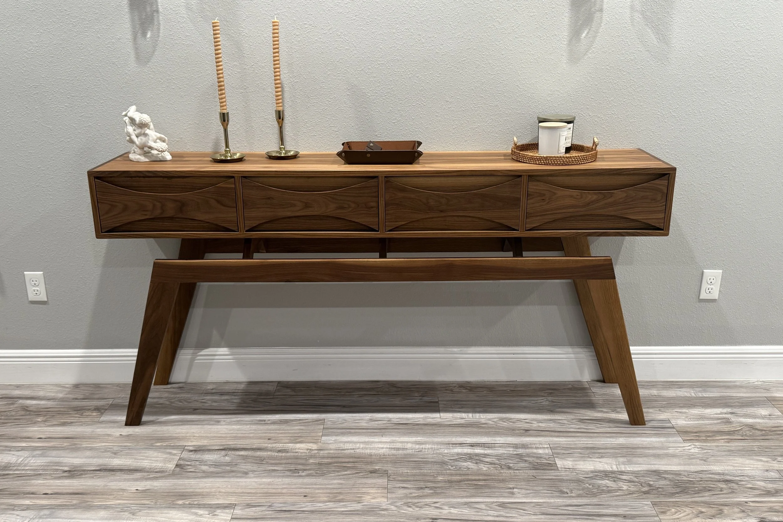 Handcrafted walnut console table with sculpted drawer fronts