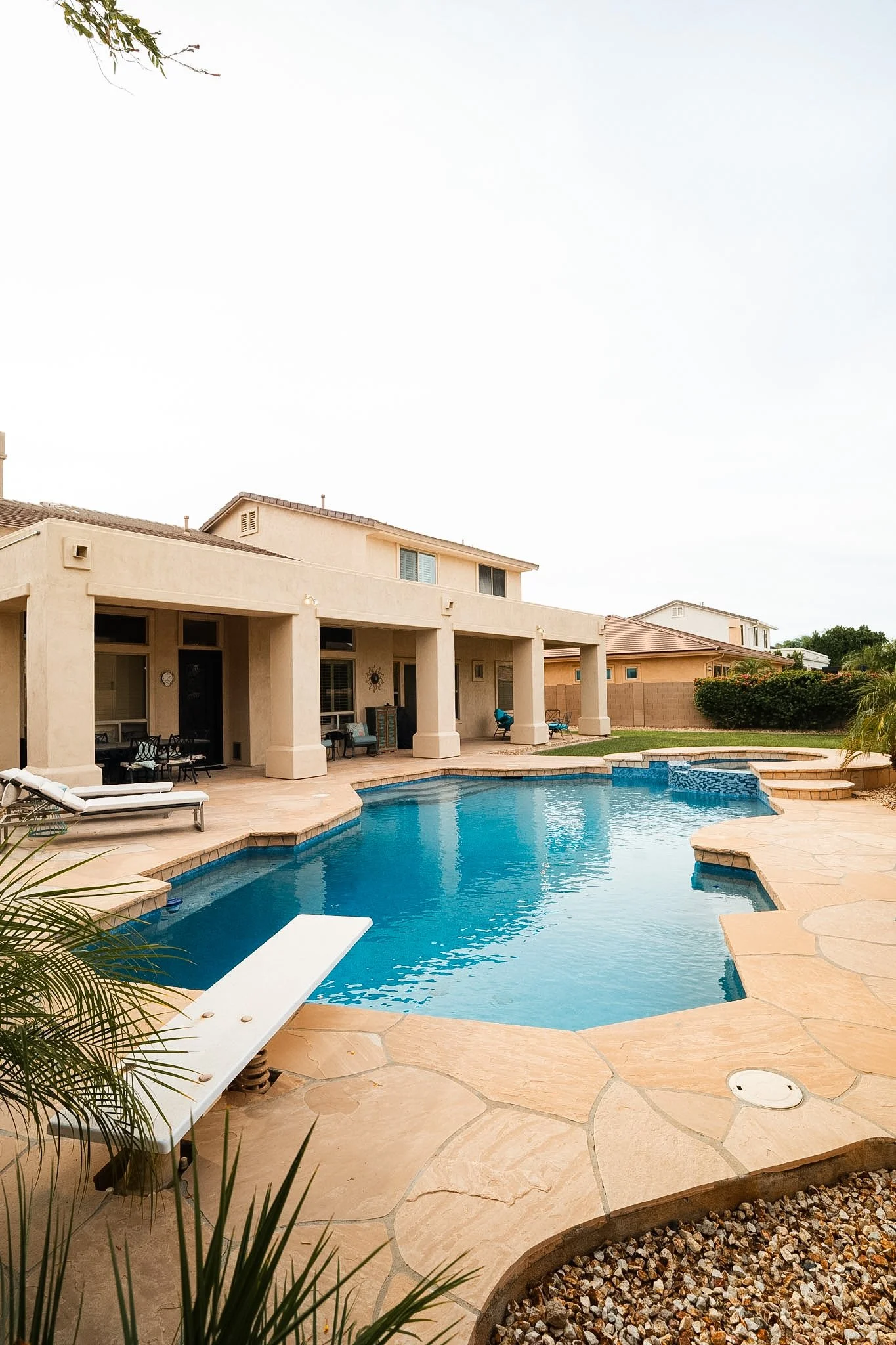 Finished remodel pool with Caribbean Blue mini pebble, 6" x 6" Blue Seas Light Blue porcelain tile, and 1" x 2" Orion Blue glass tile.