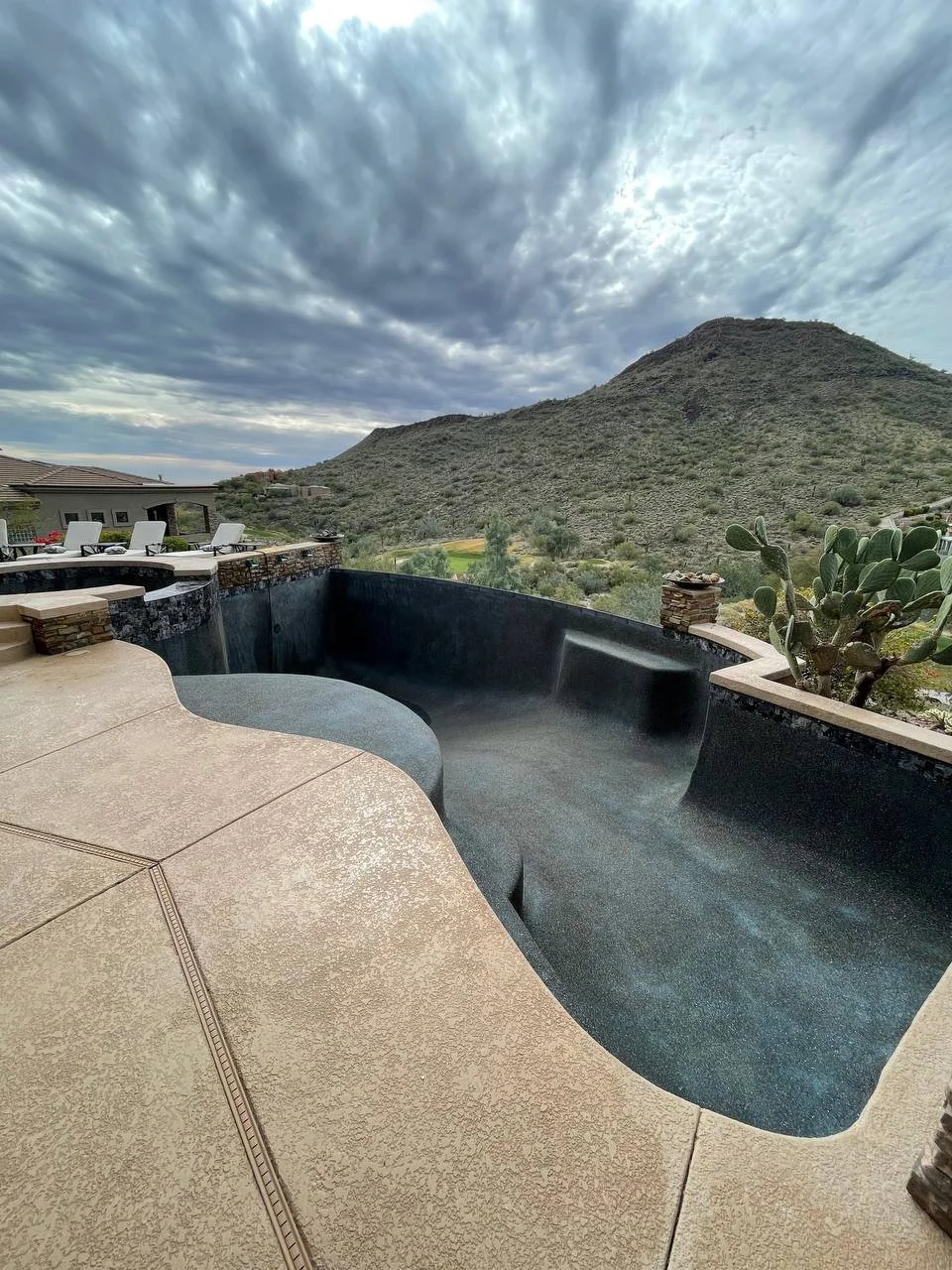Newly plastered residential swimming pool ready for filling with Arizona mountain view