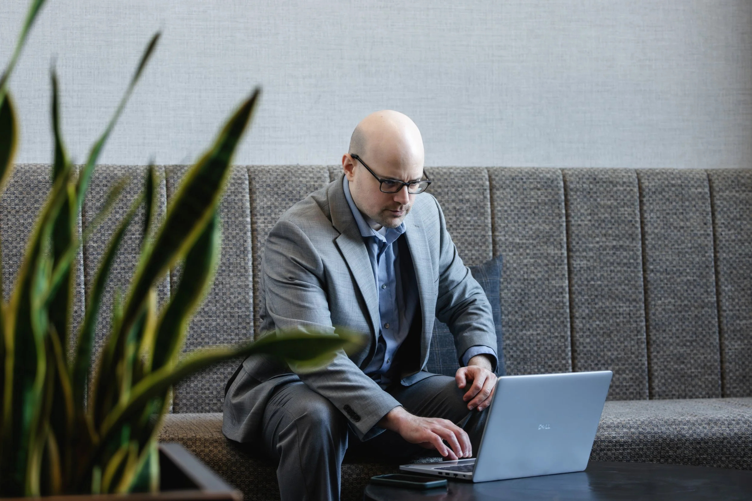 Stephen Steinbacher, founder of Steinbacher Business Advisory, working on a laptop