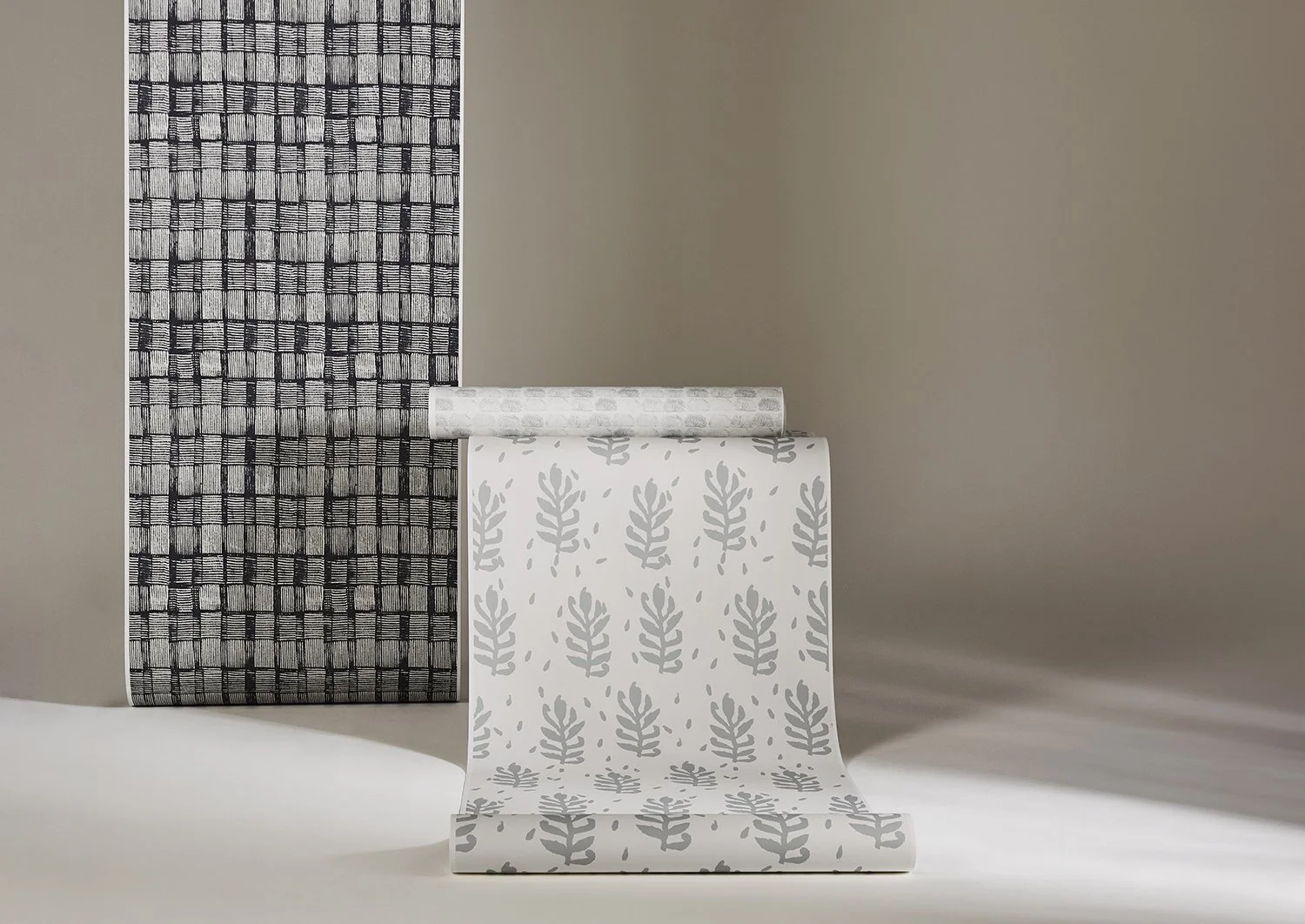 Interior with wallpaper unrolled from top with various patterns featuring First Nations designs in colours of black and white, green and pale blue
