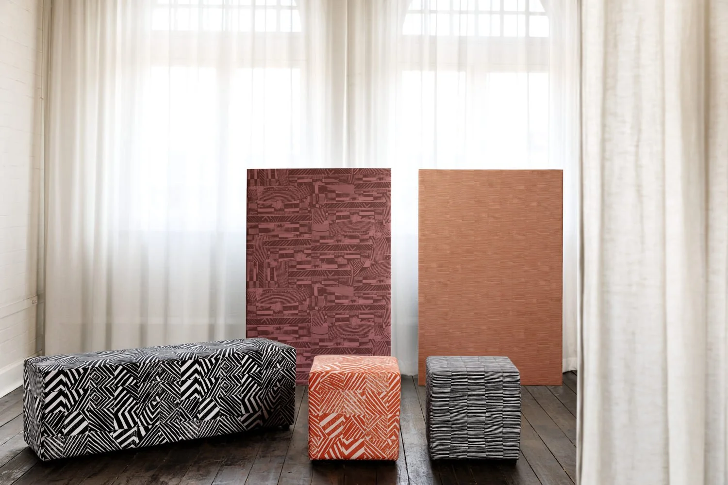 Ottomans upholstered in Willie Weston designs including Renewed 'Mono’, featuring bold, graphic artwork by First Nations artist Lisa Waup from Naarm (Melbourne).