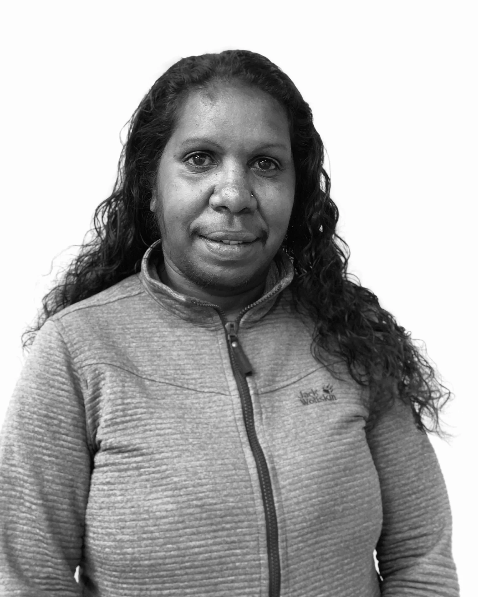 Black and white portrait of Indigenous woman with white background.