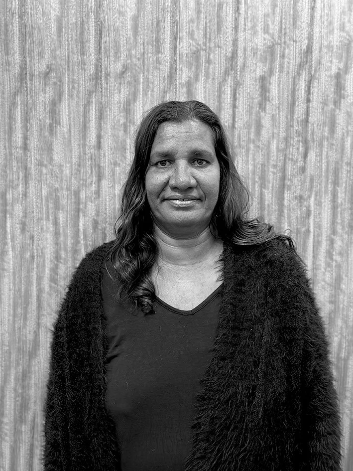 Black and white portrait of an Indigenous woman with a textured background.